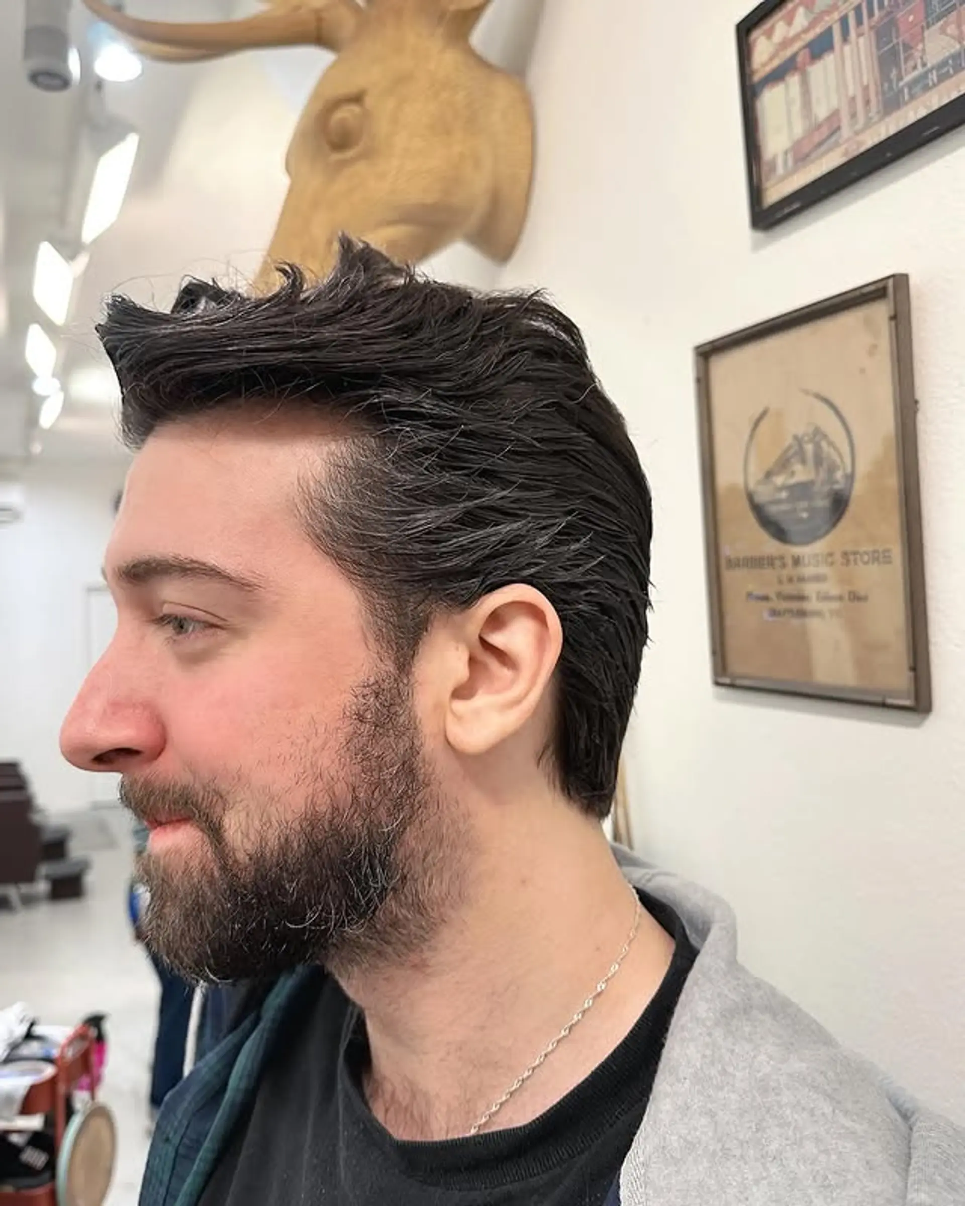 A short haircut with a textured top and faded sides. 1