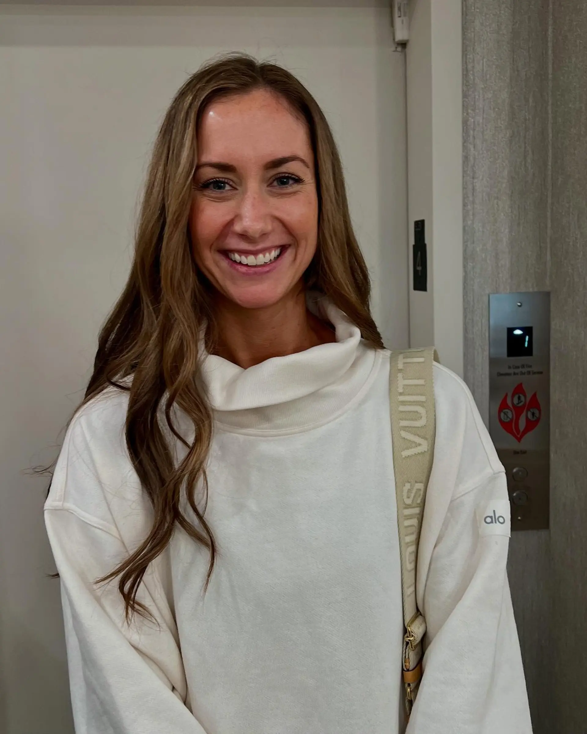 Long layered wavy hair with a bronde color melt. 1