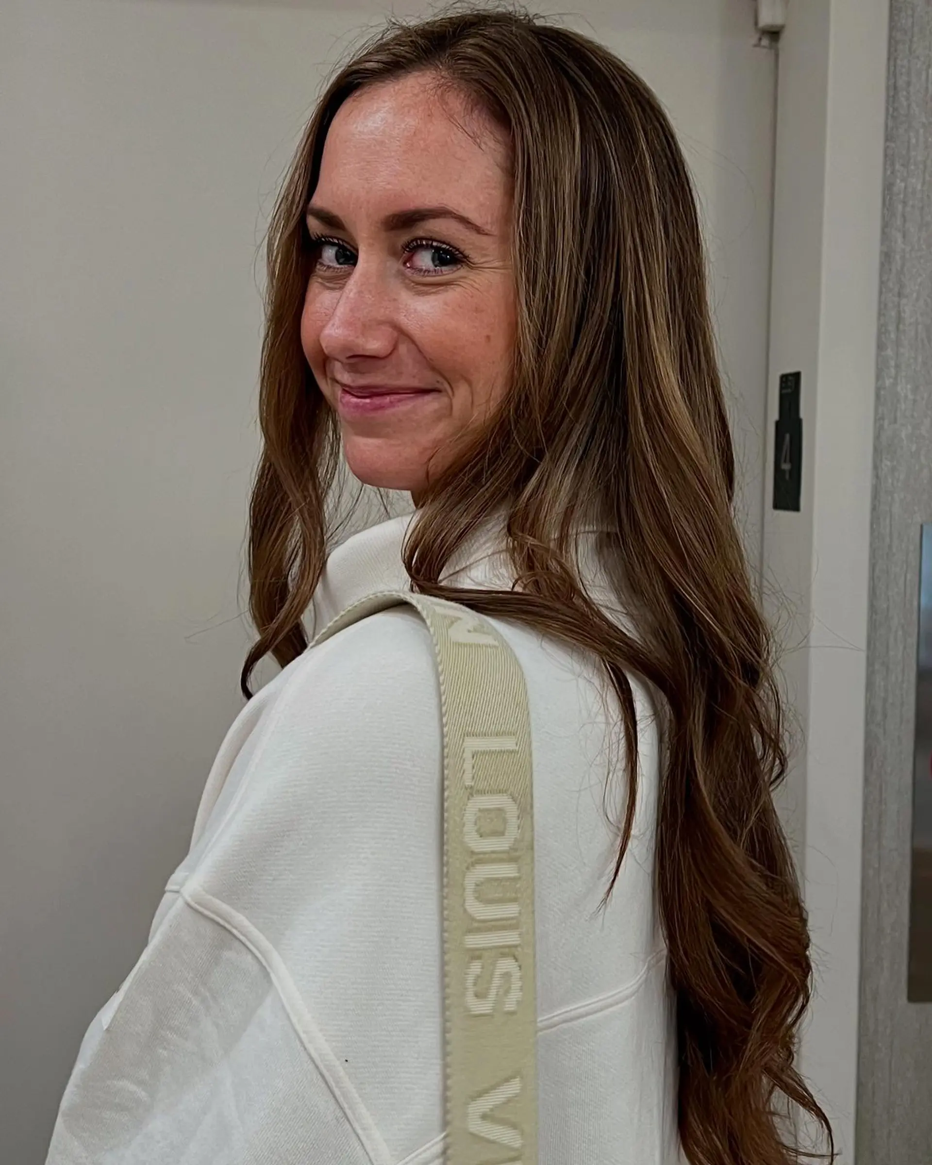 Long layered wavy hair with a bronde color melt. 2