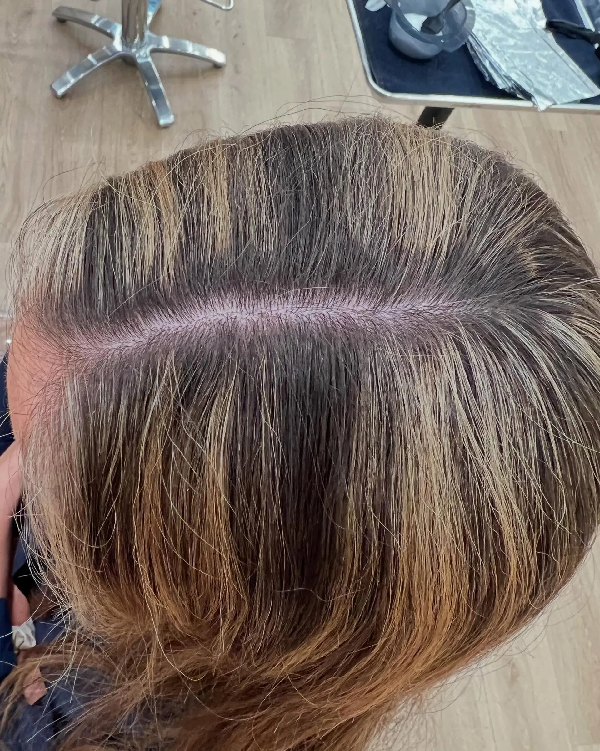 Long layered wavy hair with a bronde color melt. 3