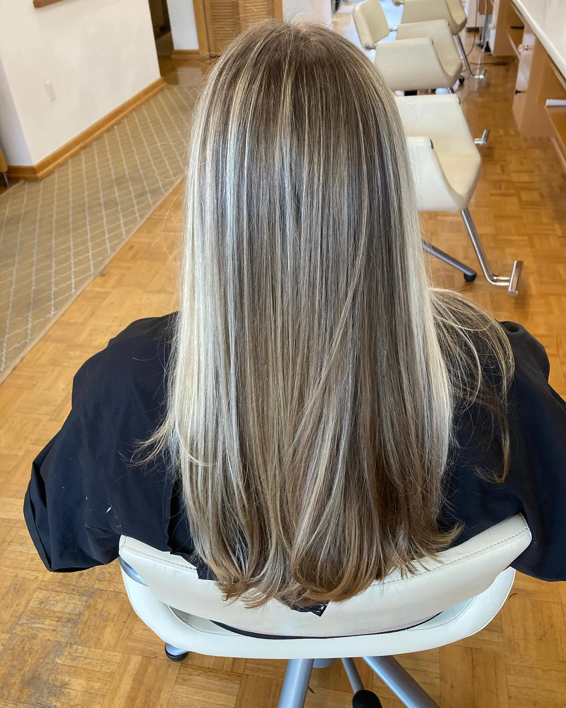 Long straight hair with fine cool blonde highlights blended through an ash brown base. 1