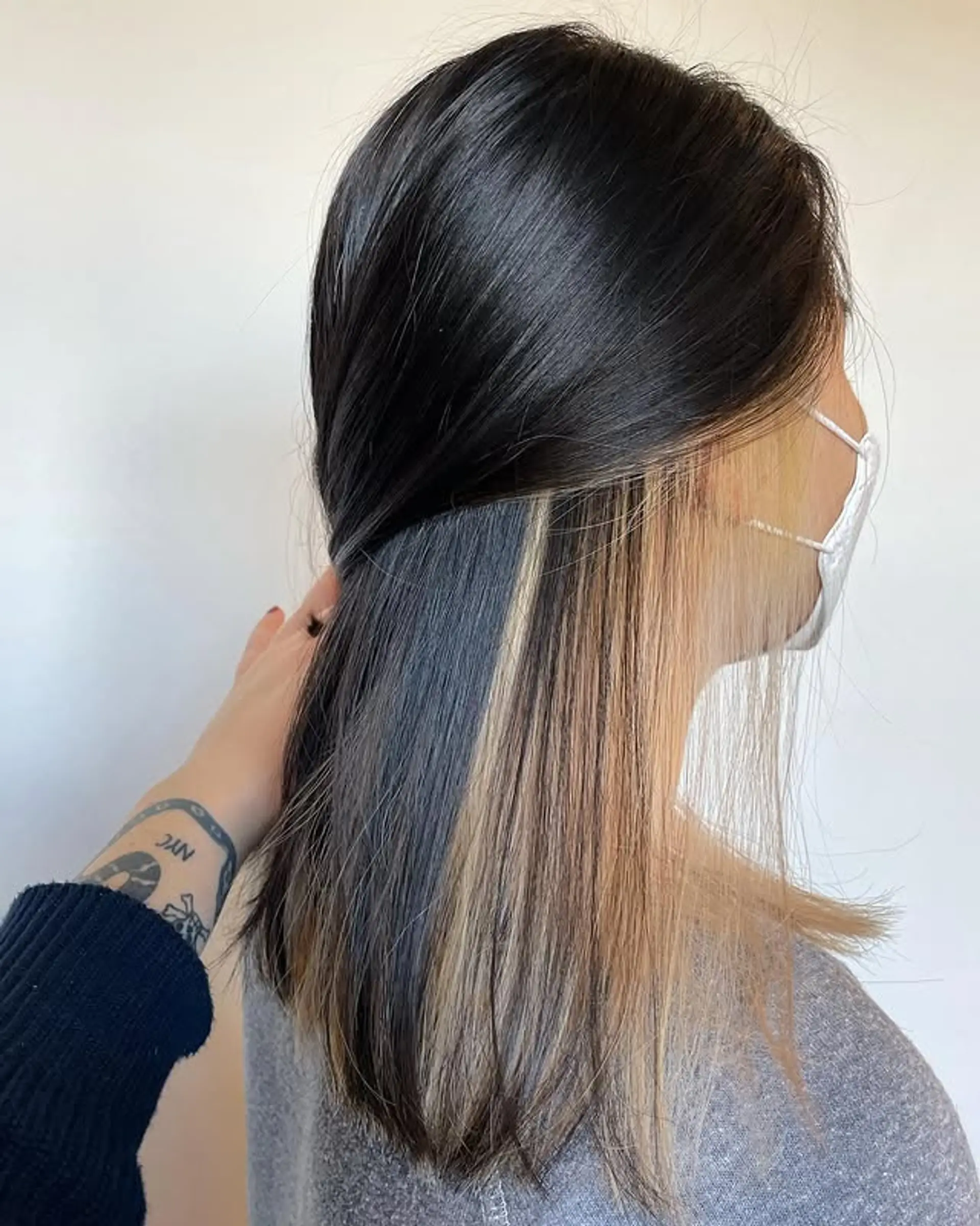 A trendy medium length straight hairstyle with hidden color block highlights. 1