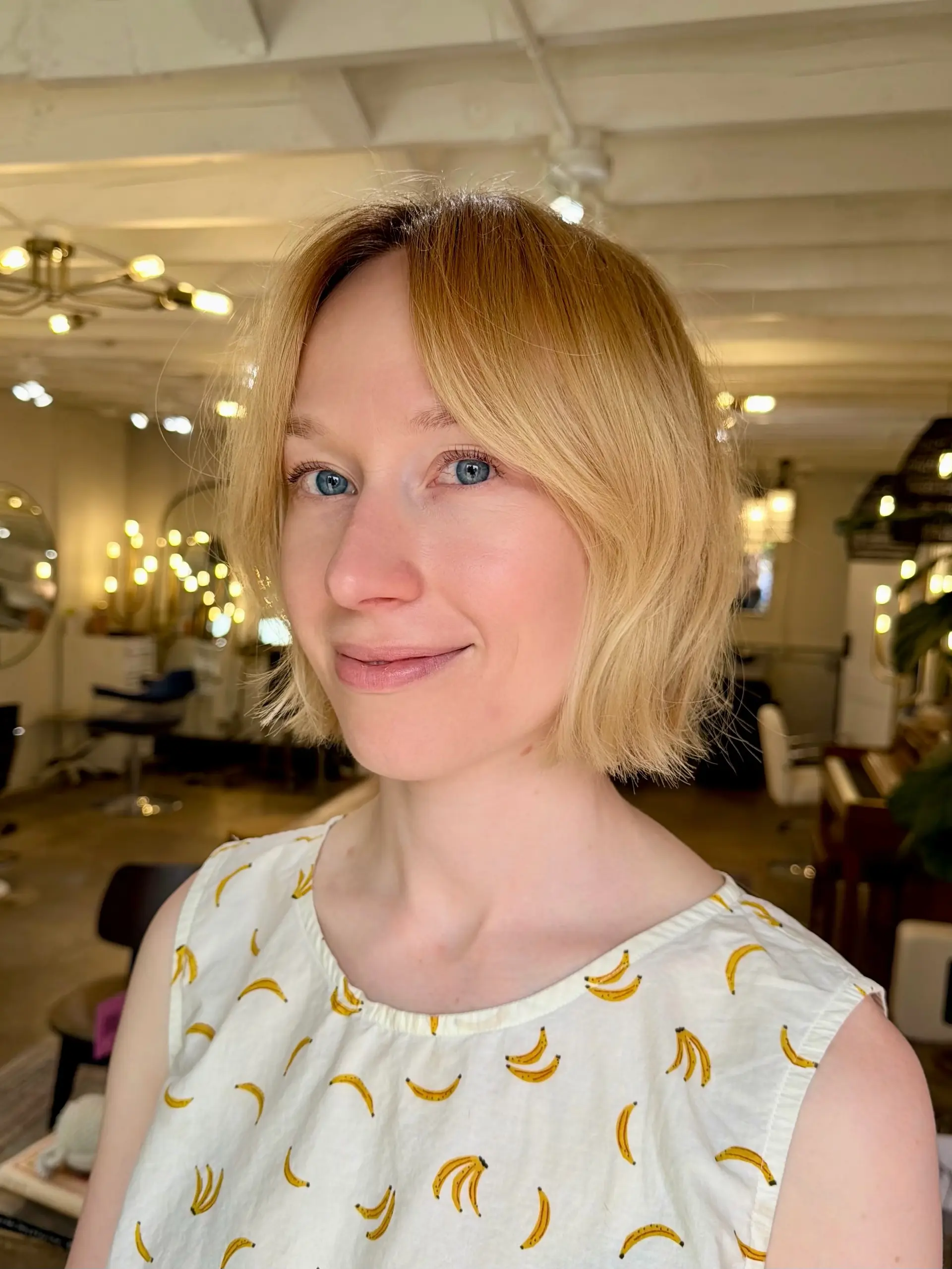 A chin-length textured blonde bob with soft, center-parted fringe framing the face. 1