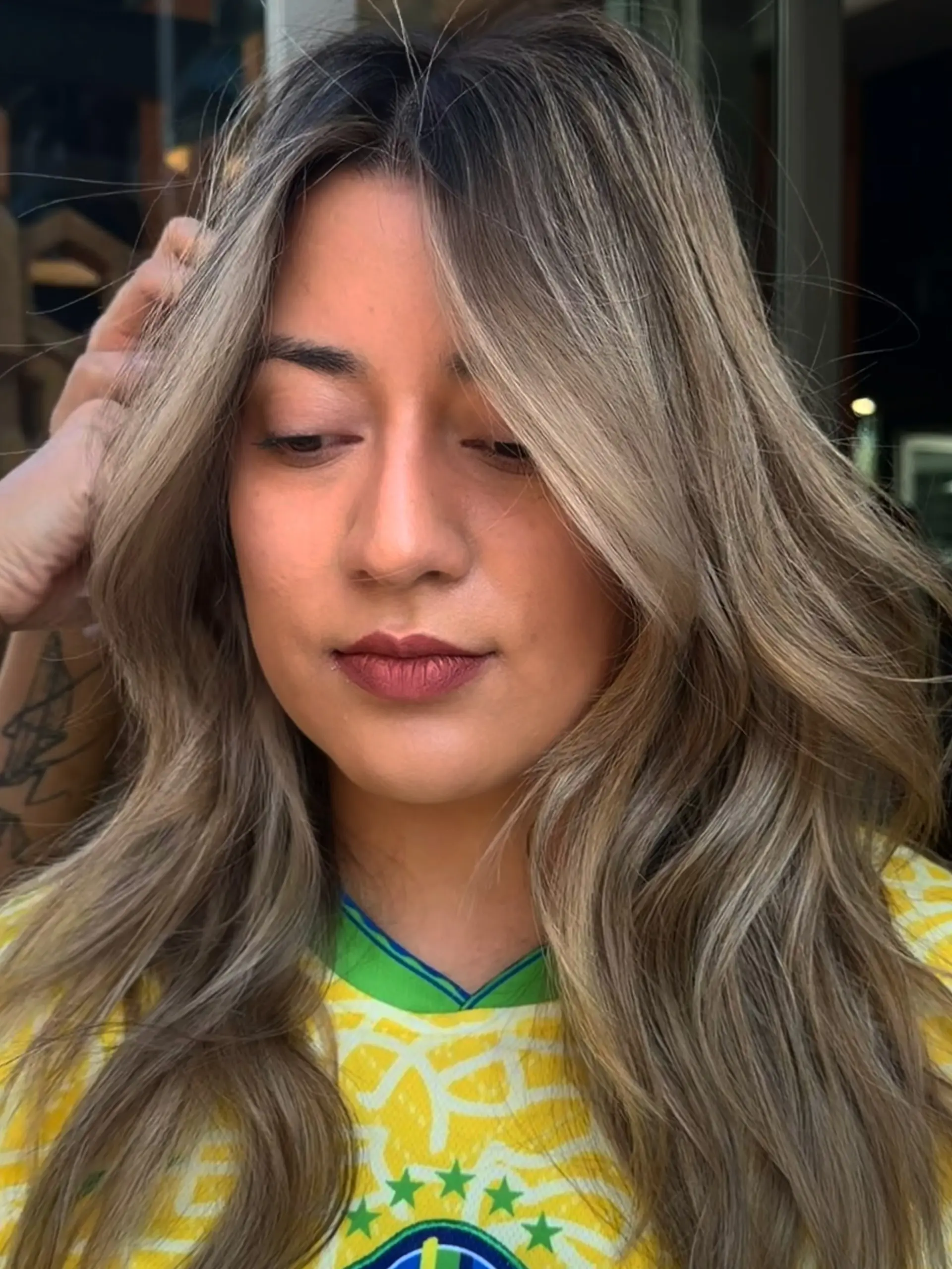 Long beige blonde hair featuring seamless balayage highlights styled in soft, textured waves with face-framing layers. 1