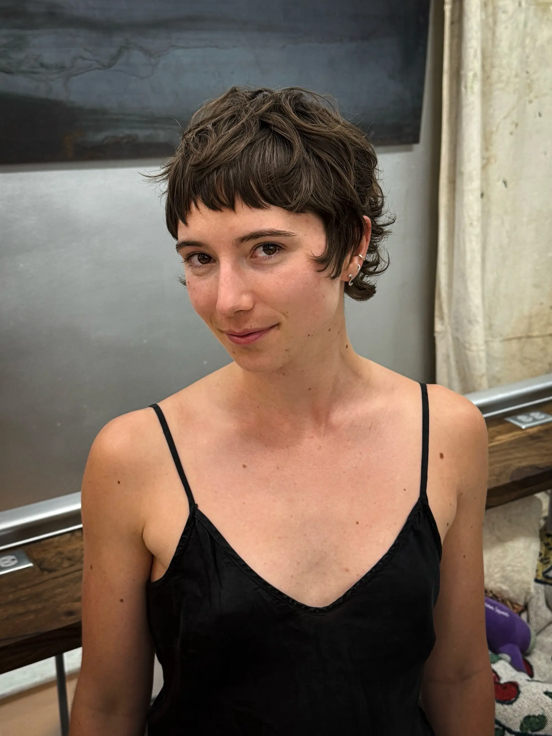 A short, wavy shag haircut with choppy layers and very short, micro bangs. 4