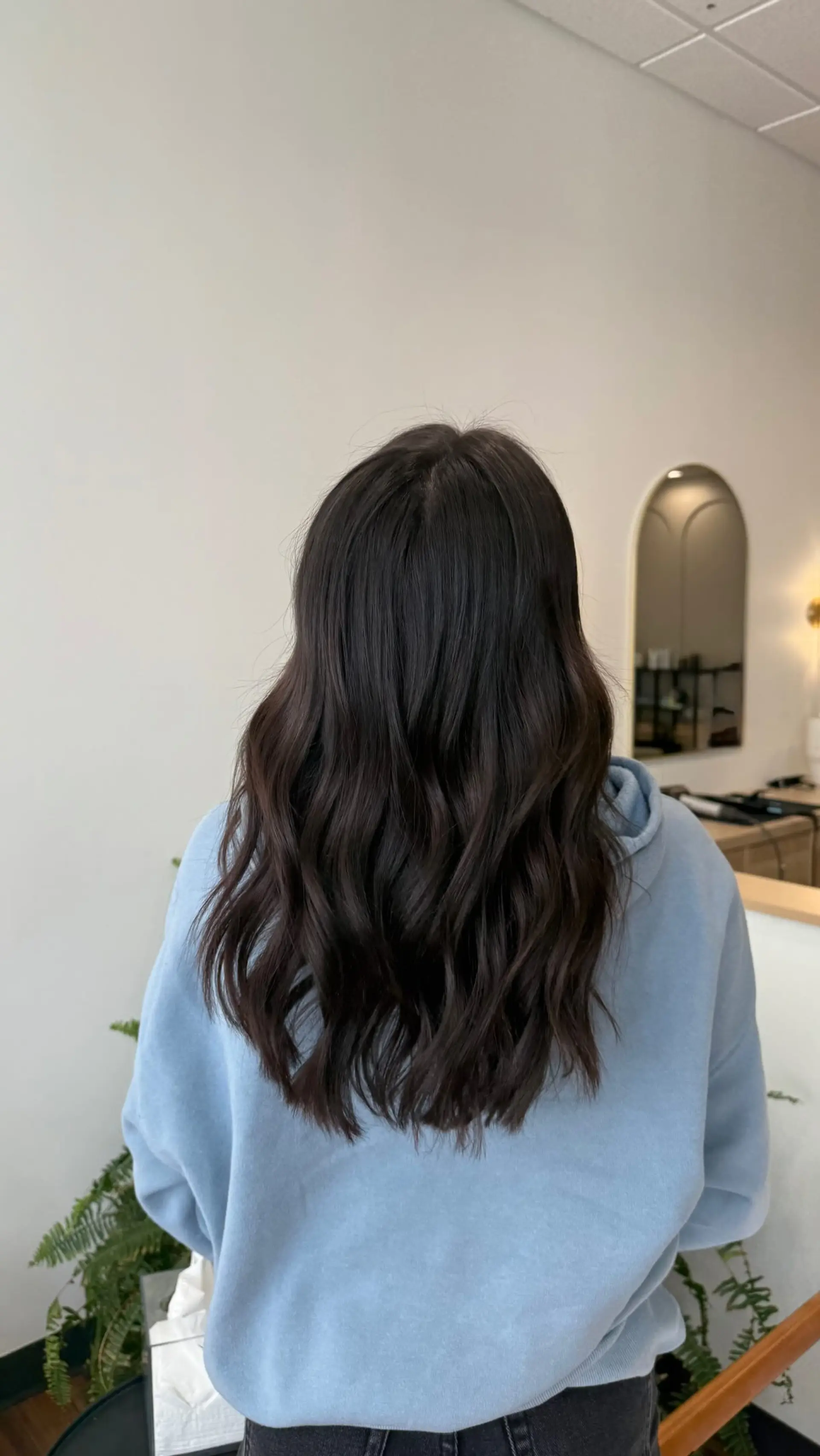 Long, rich dark brunette hair styled in loose, soft textured waves. 1