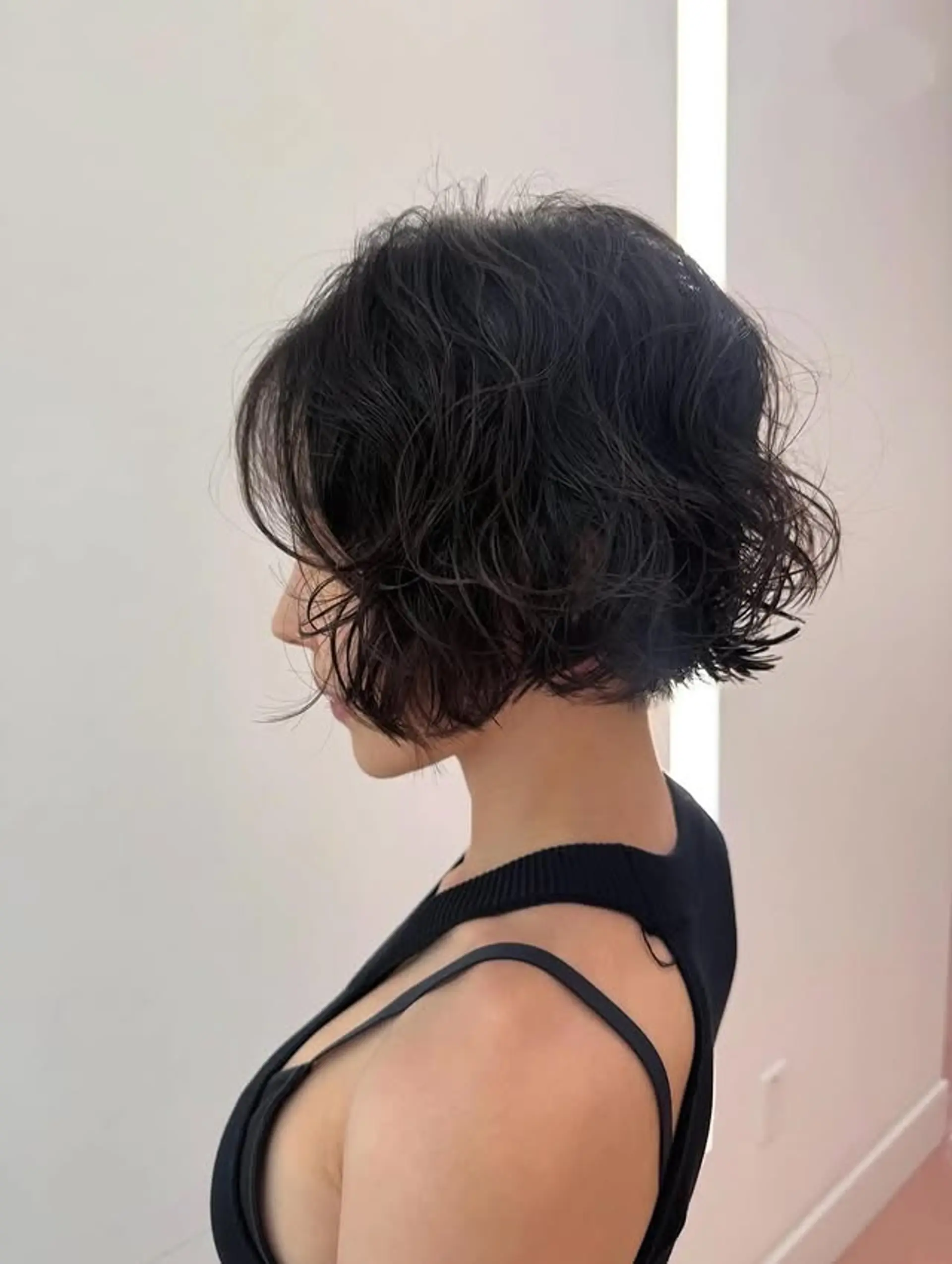 A short, wavy bob with a blunt cut and textured finish. 1