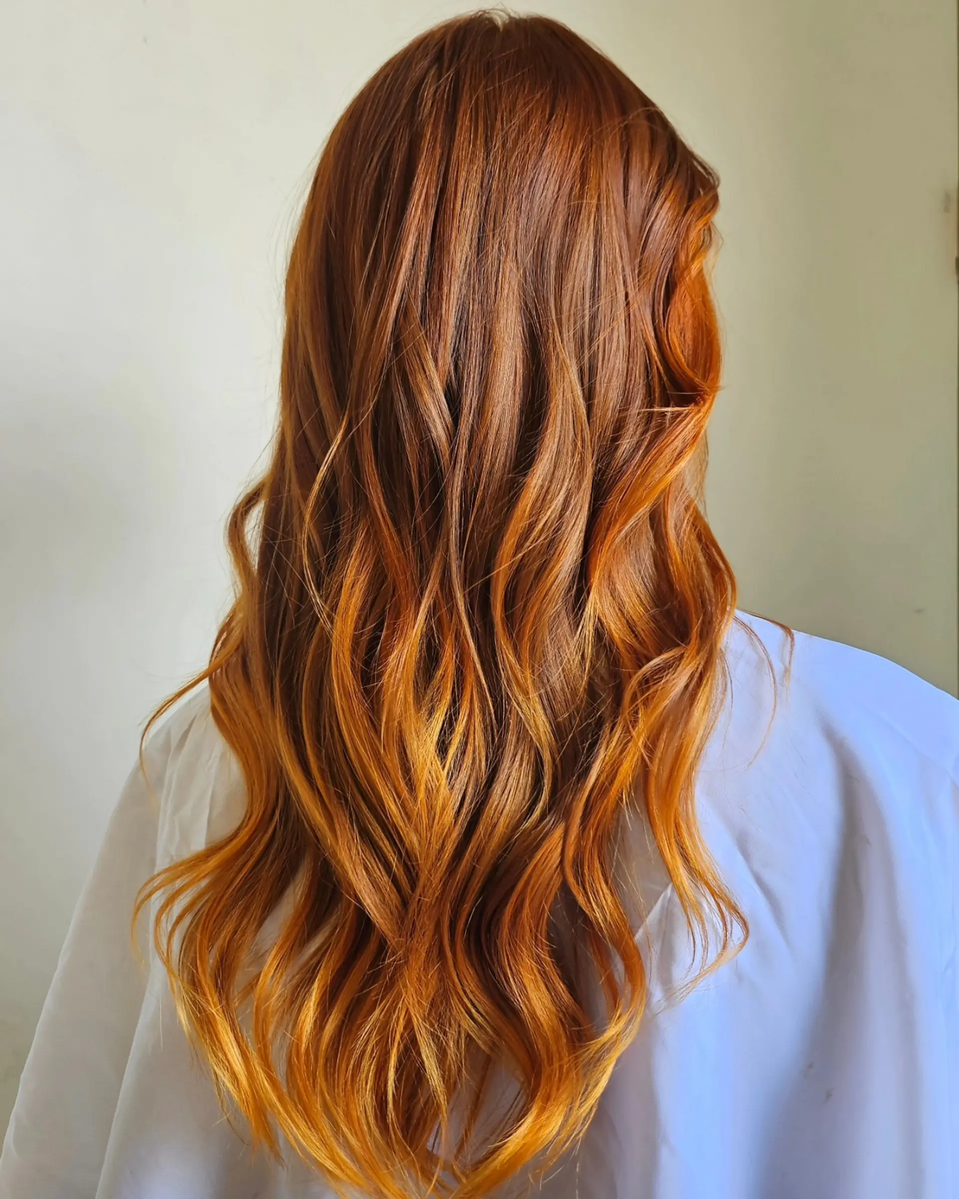 Long, luminous copper hair styled into gentle cascading waves. 1