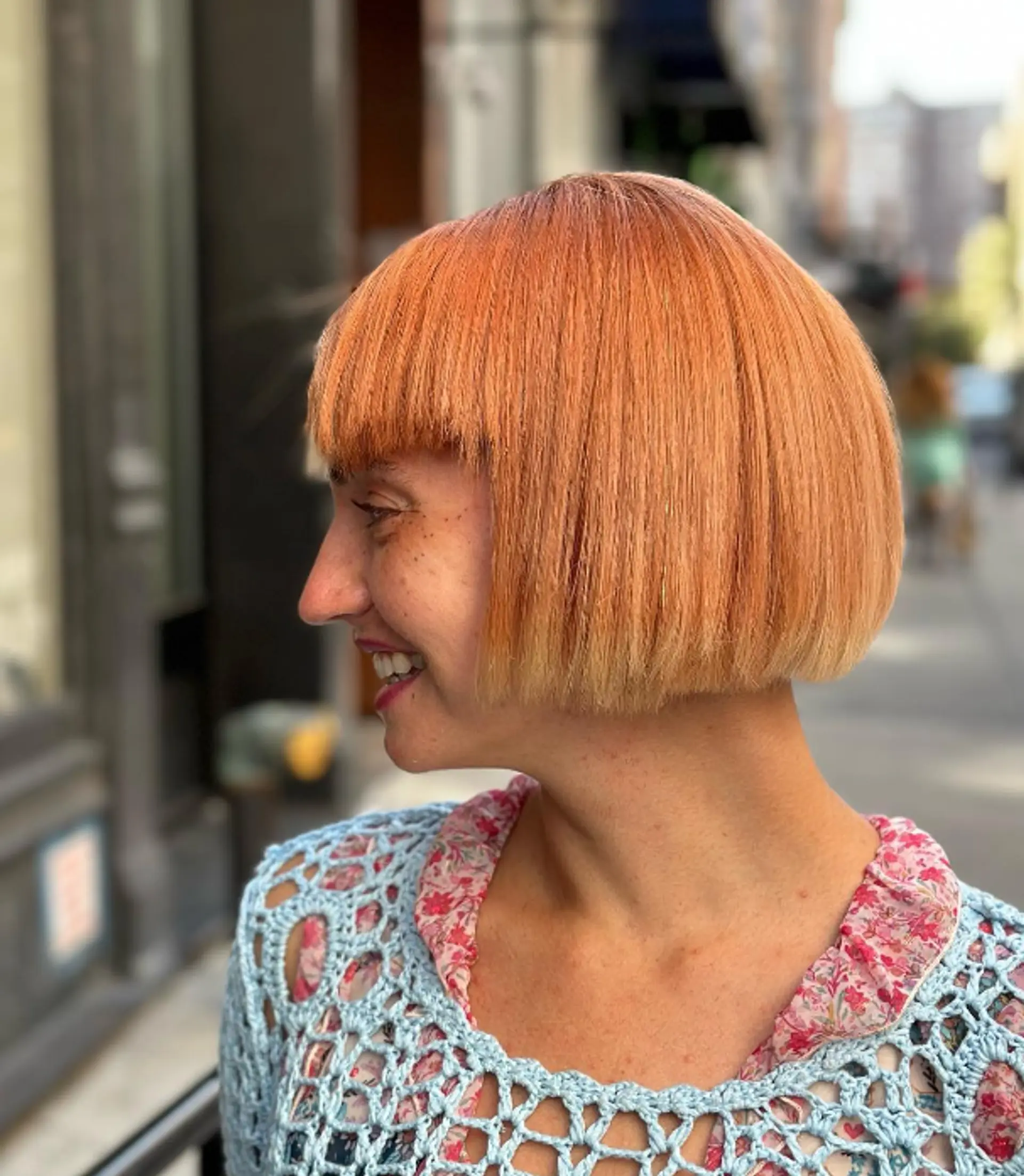 A short, straight, light orange bob with a blunt cut, straight fringe, glossy finish, and soft layers.


 1