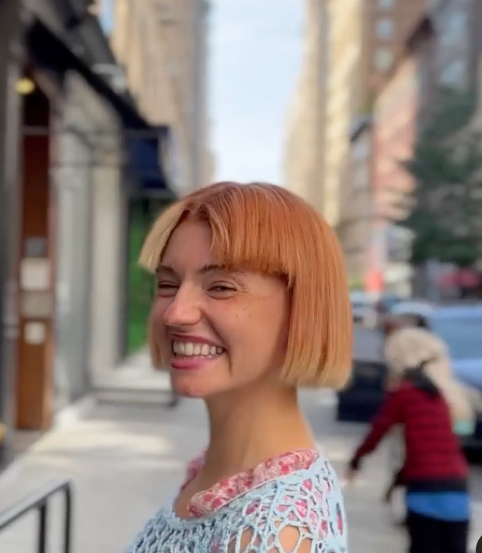 A short, straight, light orange bob with a blunt cut, straight fringe, glossy finish, and soft layers.


 3