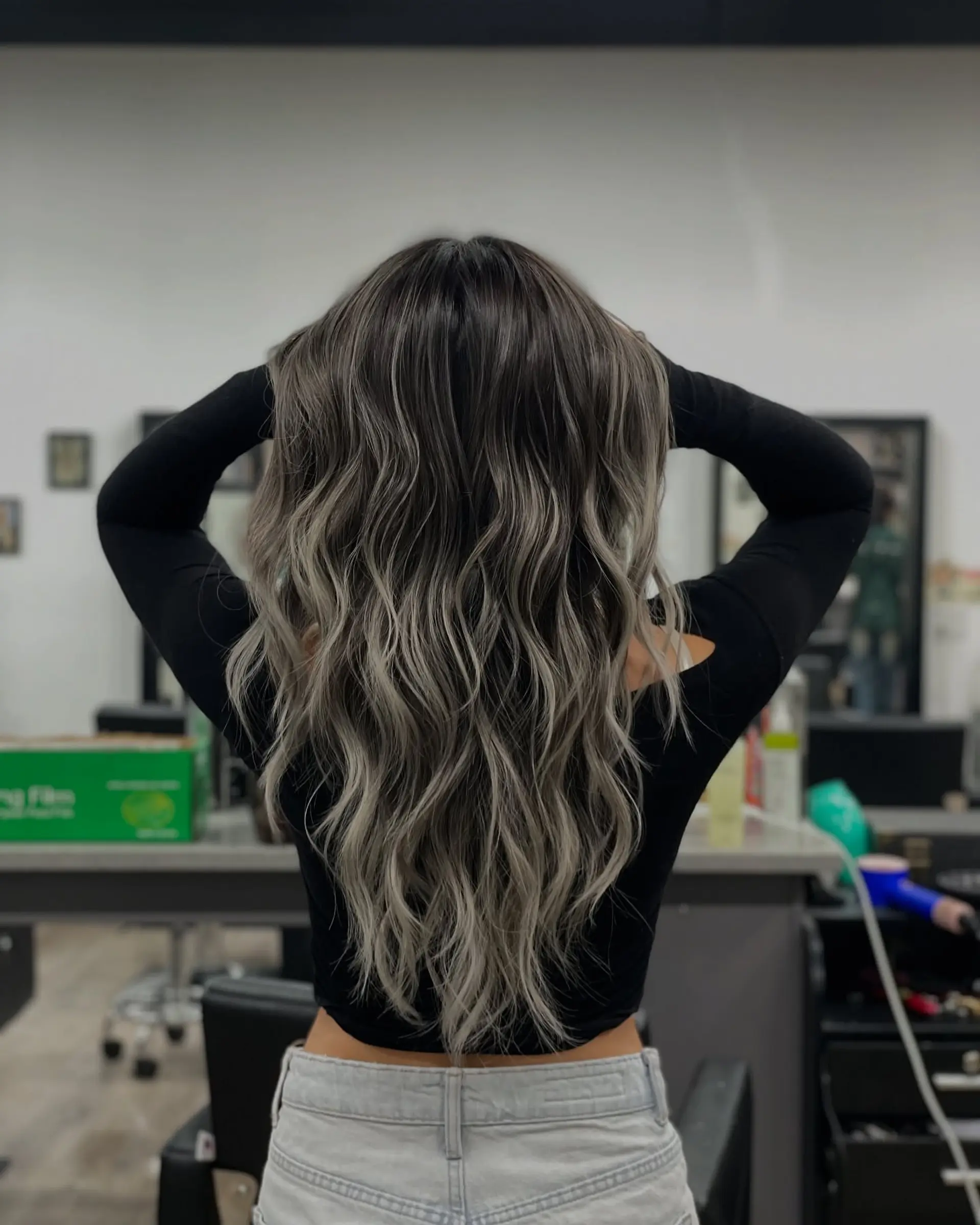 Long wavy hair with a seamless black to silver ash blonde balayage. 1