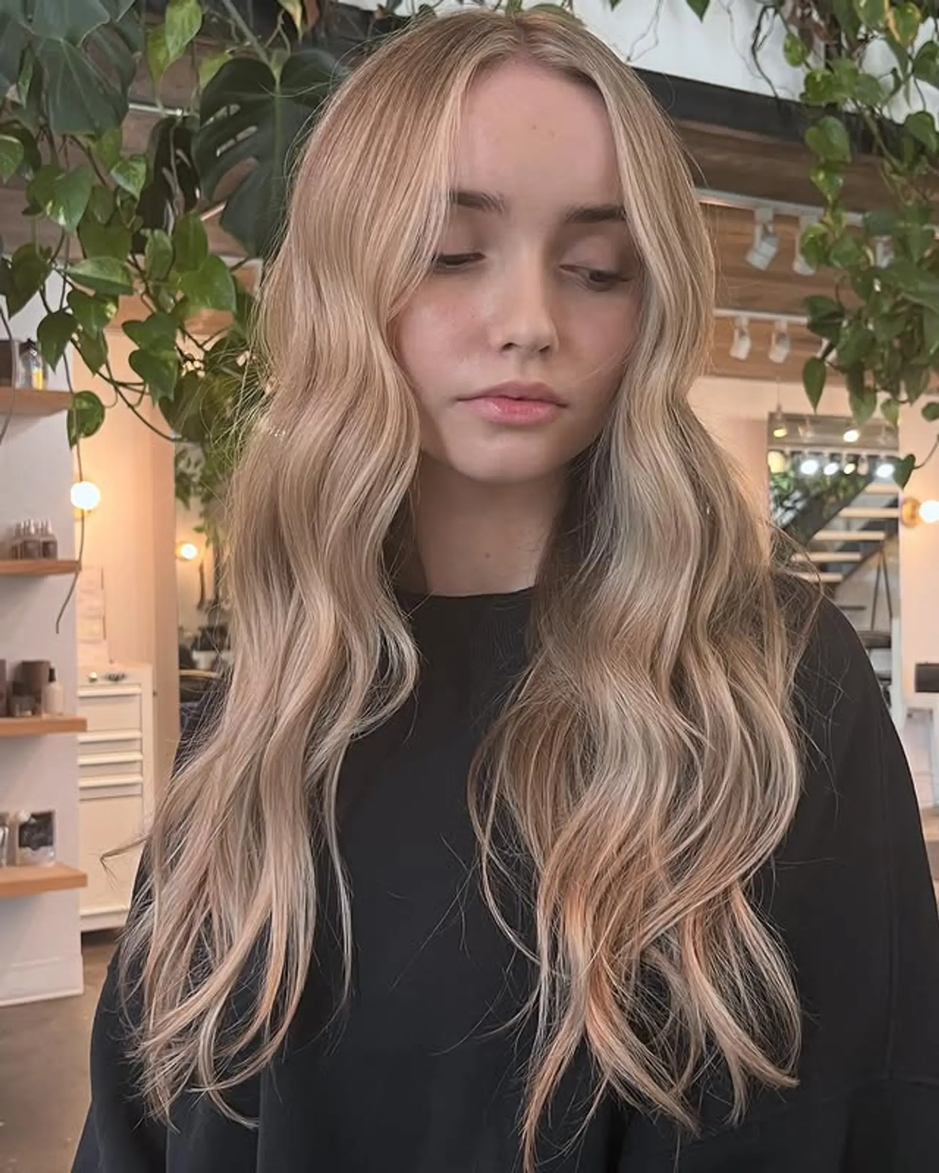 Long, wavy hair with curtain bangs creates a soft and romantic look with natural movement and face-framing layers. 1