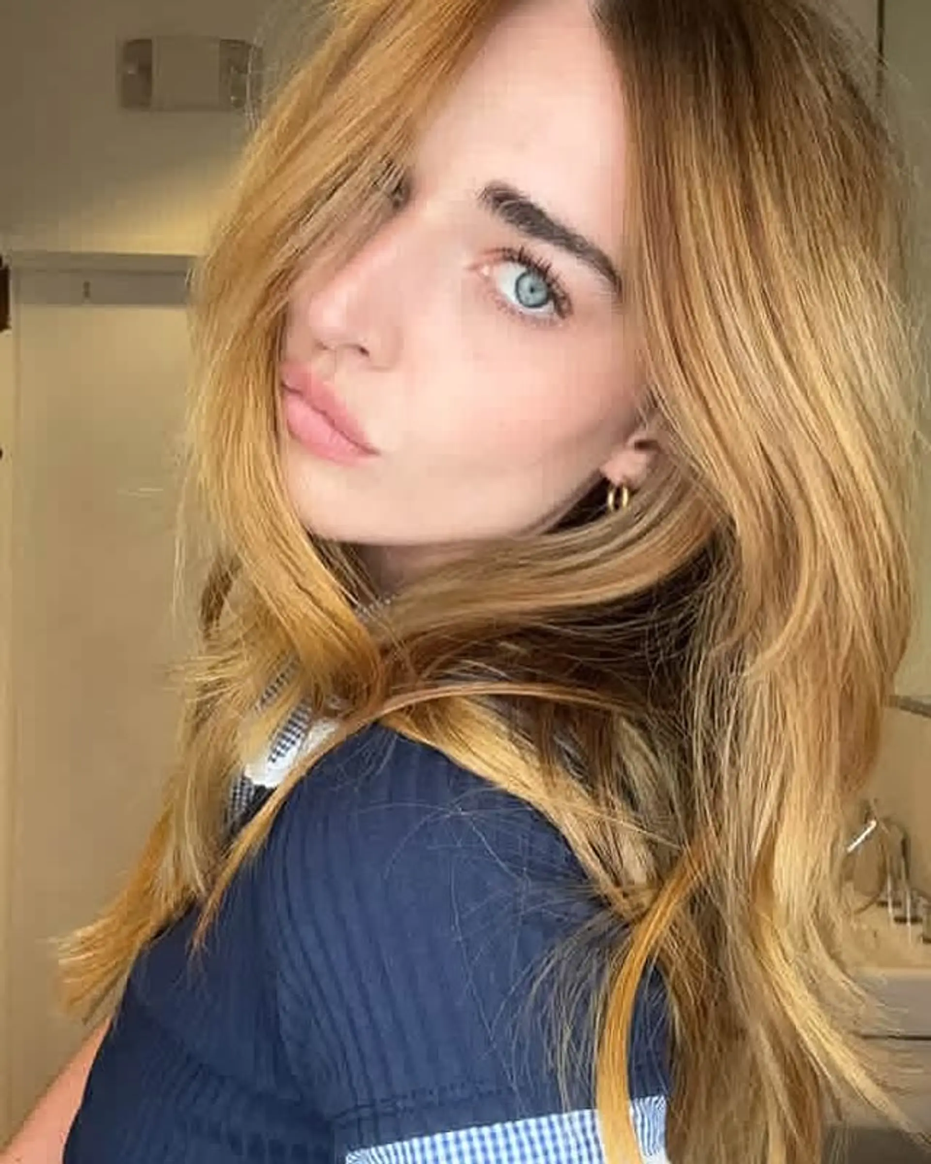 A medium-length layered haircut with face-framing layers. 1