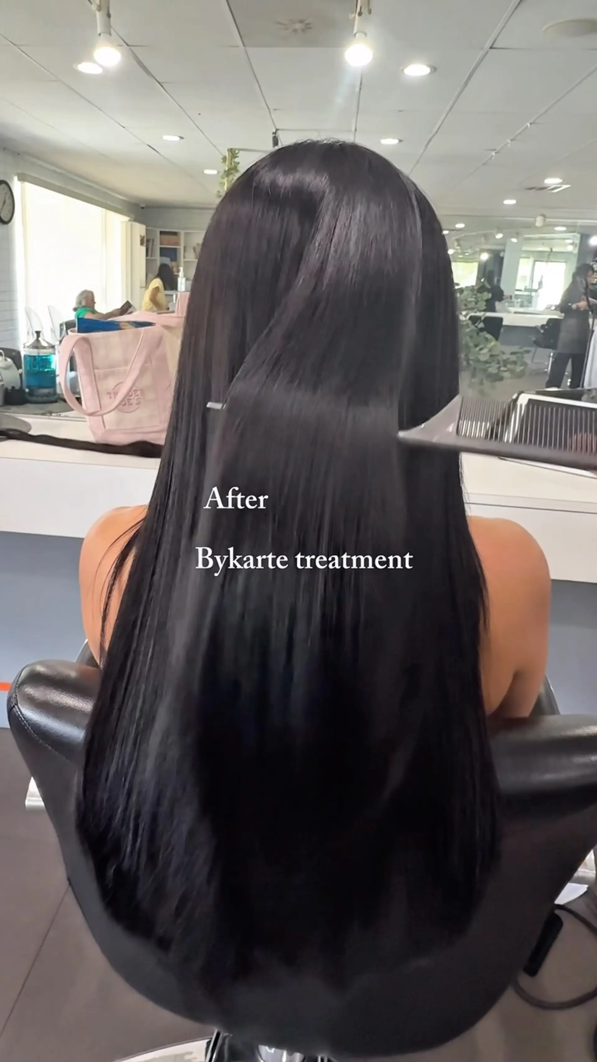 Long, sleek, and glossy straight black hair shown from behind after a conditioning treatment. 1