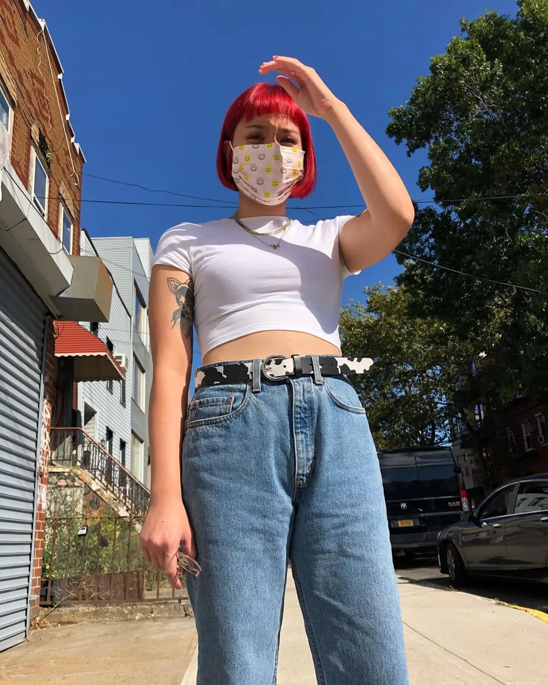 A vivid red, straight bob with blunt bangs at ear-length, featuring a sleek and glossy finish. 3