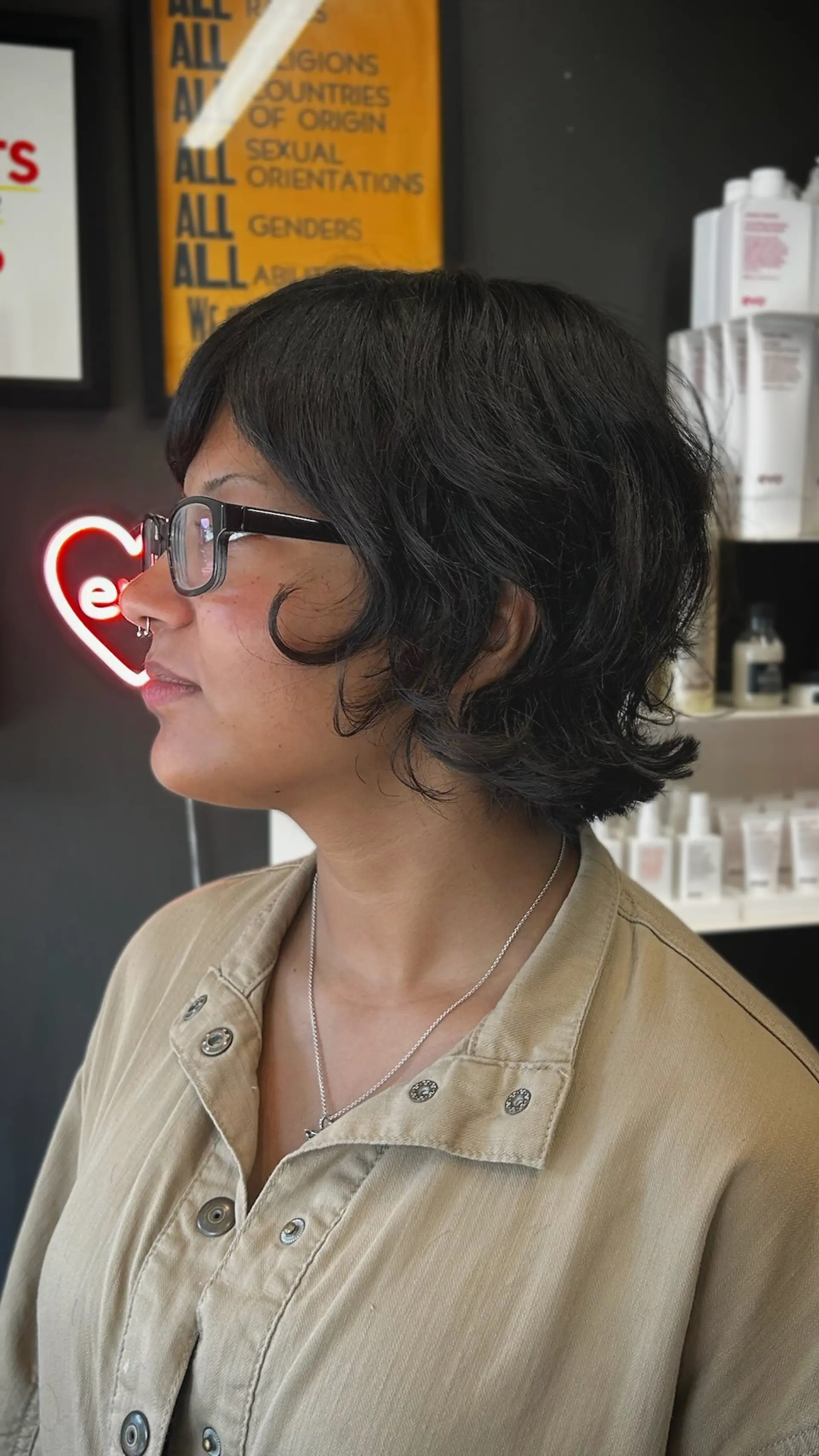 A textured short layered bob with soft, wispy bangs and flicked ends framing the jawline. 1