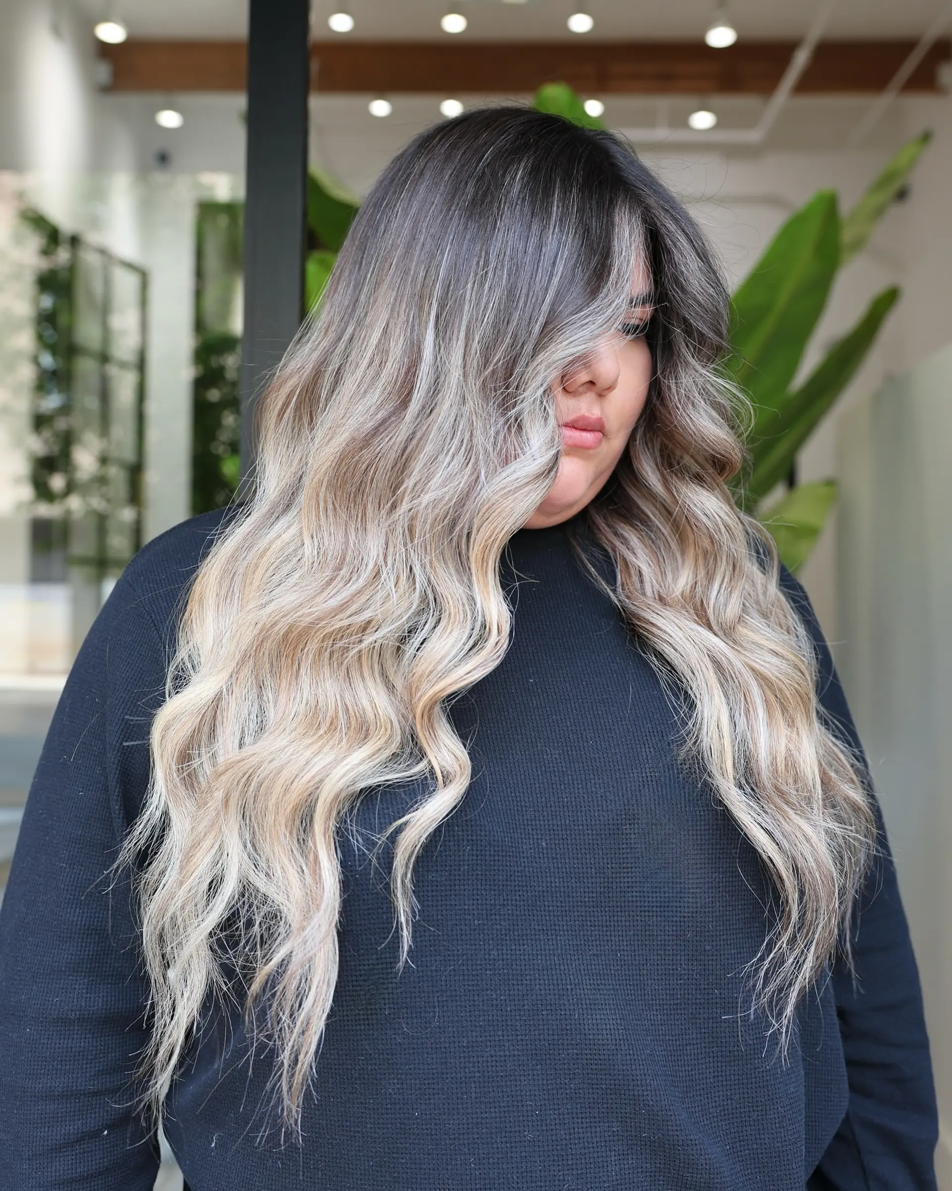 Long wavy hair with a seamless ash blonde balayage. 1