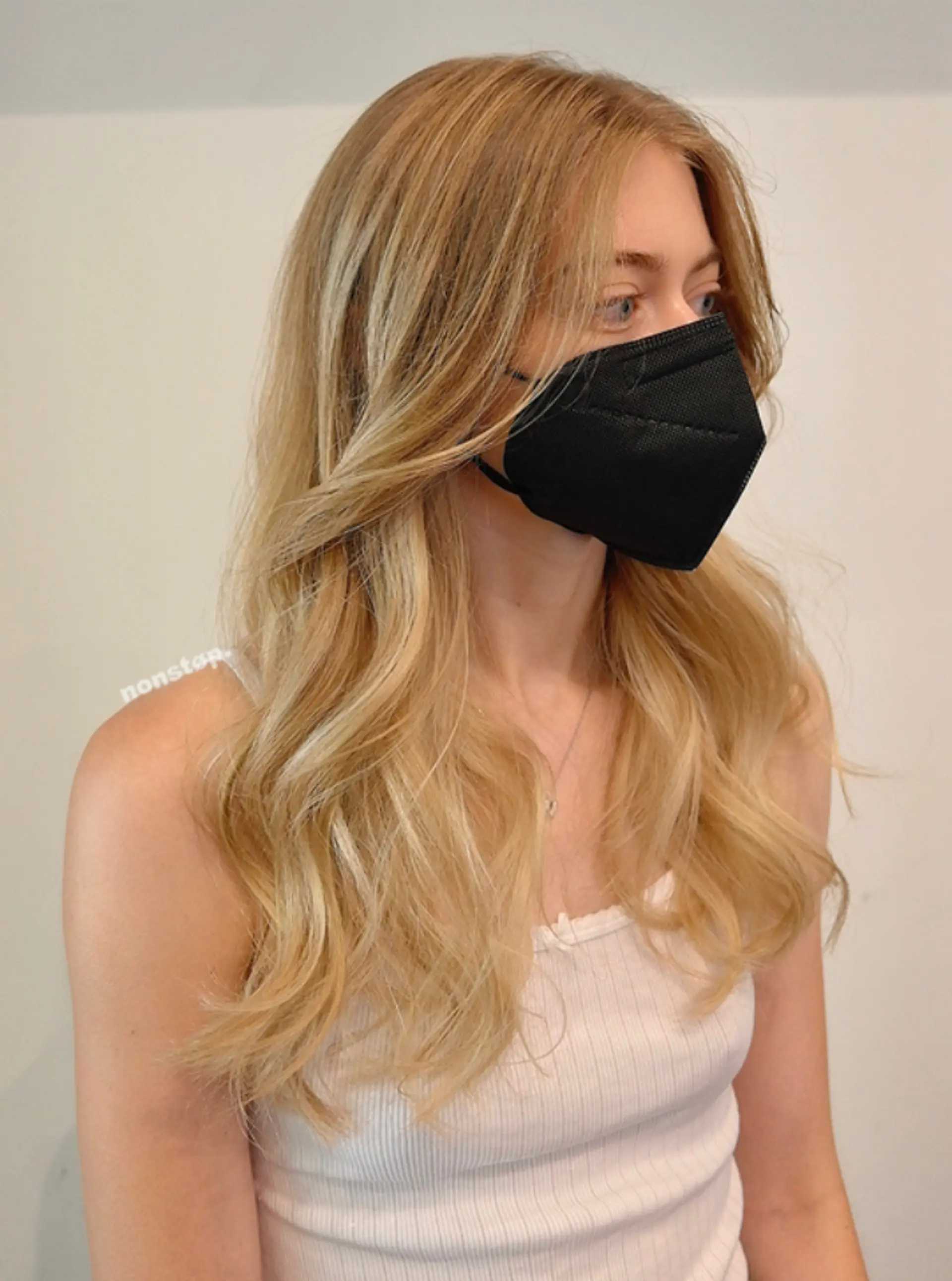 Long, wavy blonde hair parted to the side with natural cascading waves and layered for added volume and movement.

(NonstopStyle: by Kelvin) 1