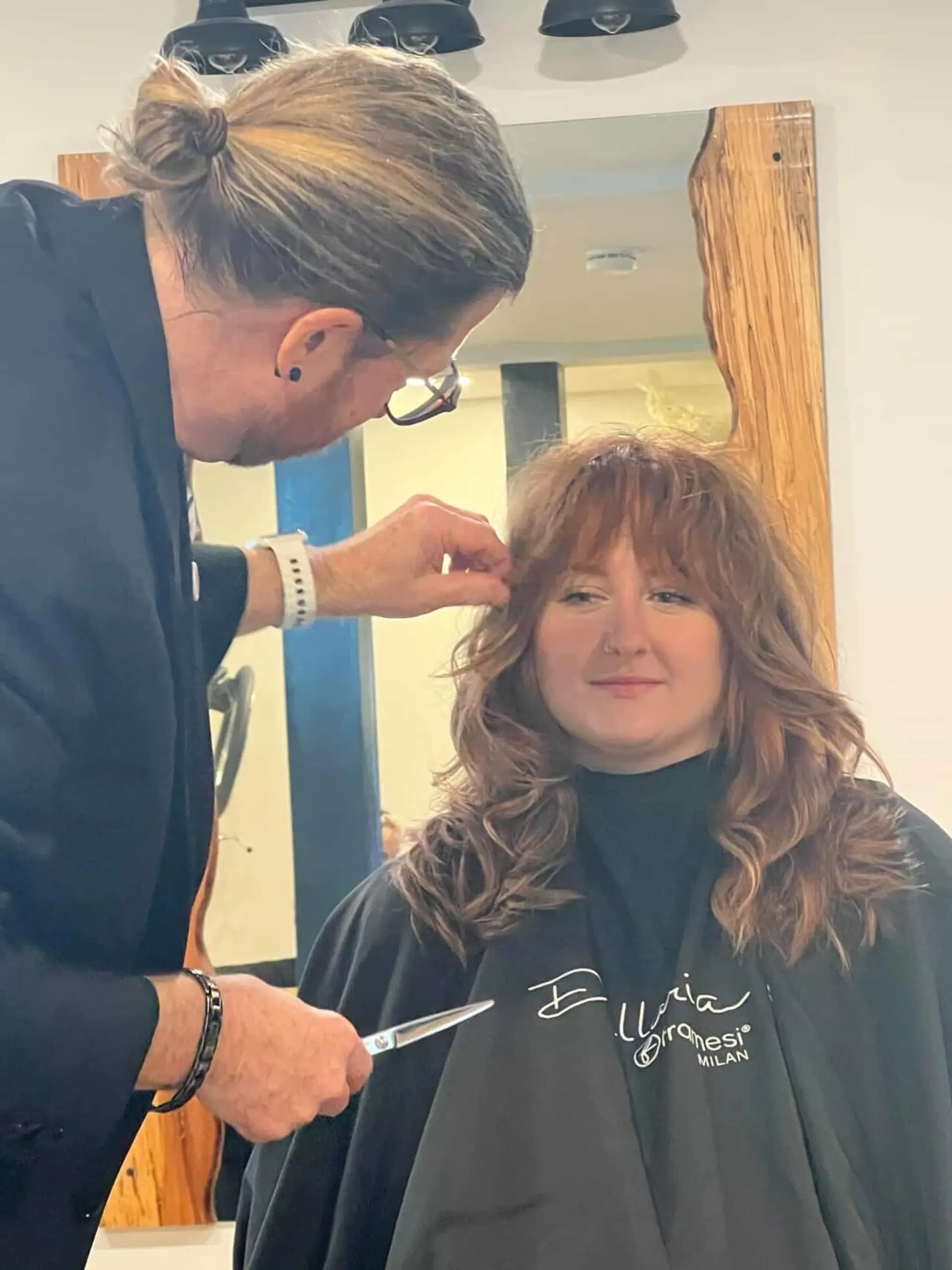 A textured, mid-length shag cut with full feathered bangs and layered soft waves. 1