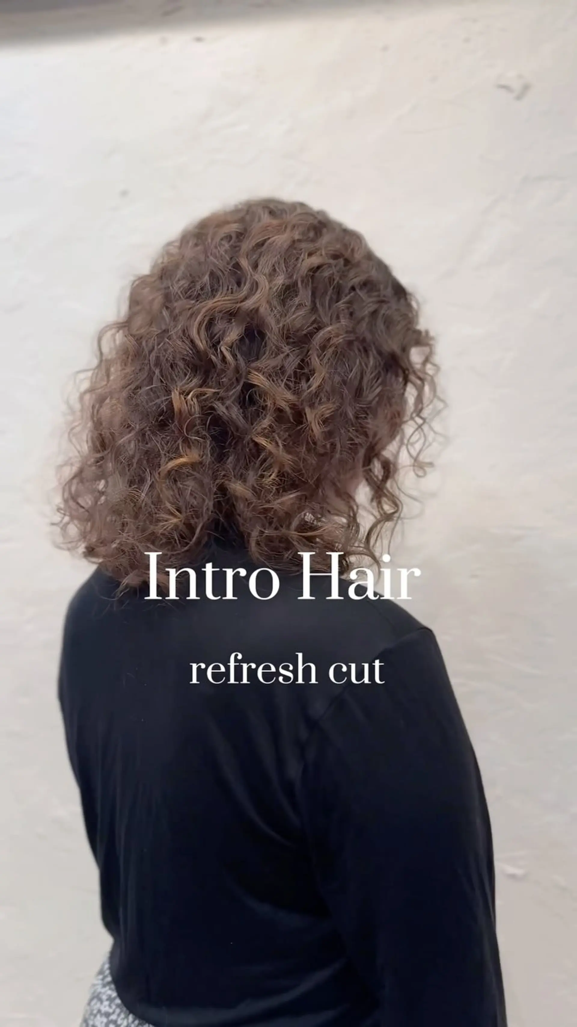A layered shoulder-length curly haircut with natural volume and defined ringlets. 1