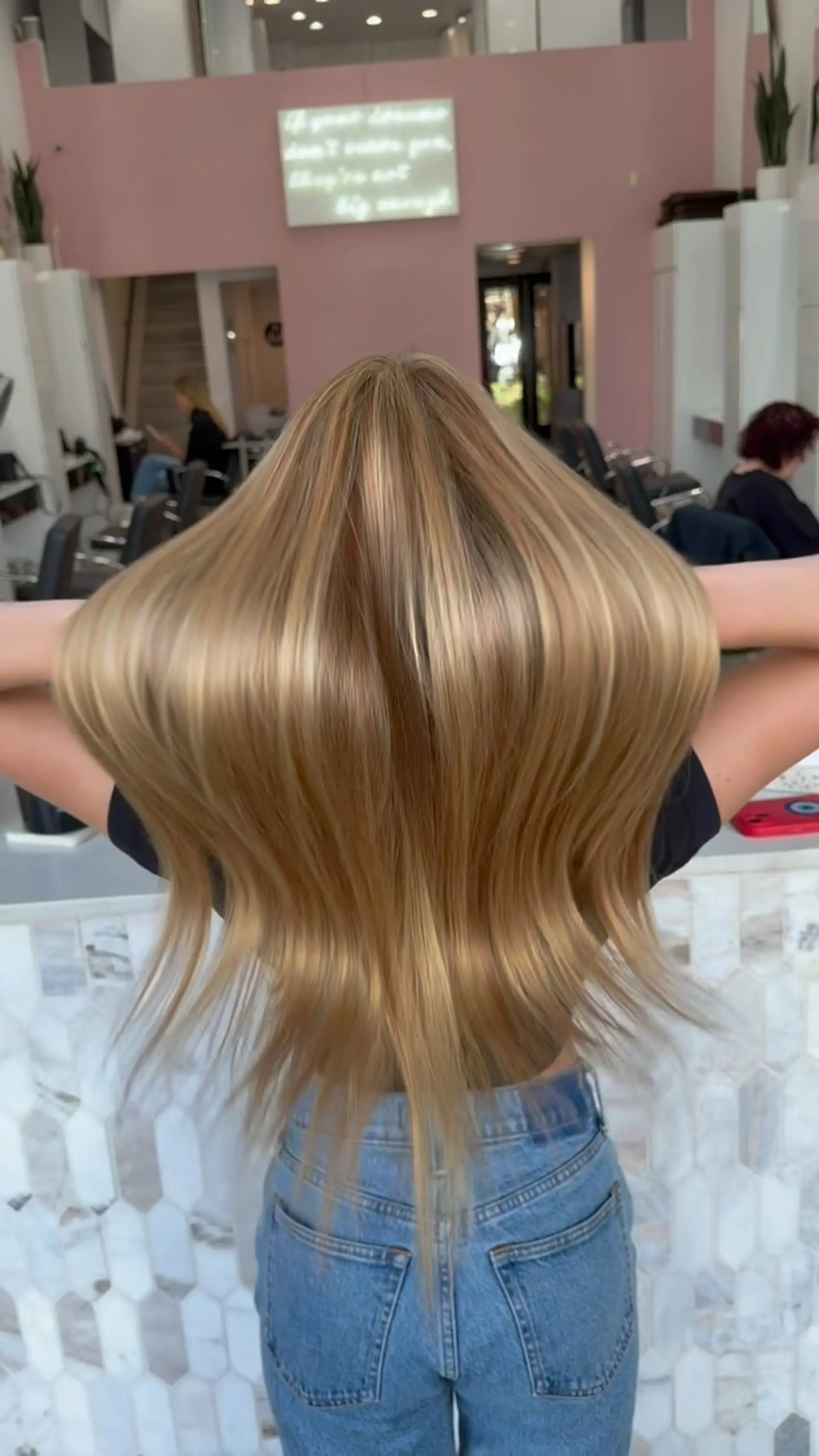 Long, sleek straight hair showcasing radiant sun-kissed warm blonde highlights with high shine. 1