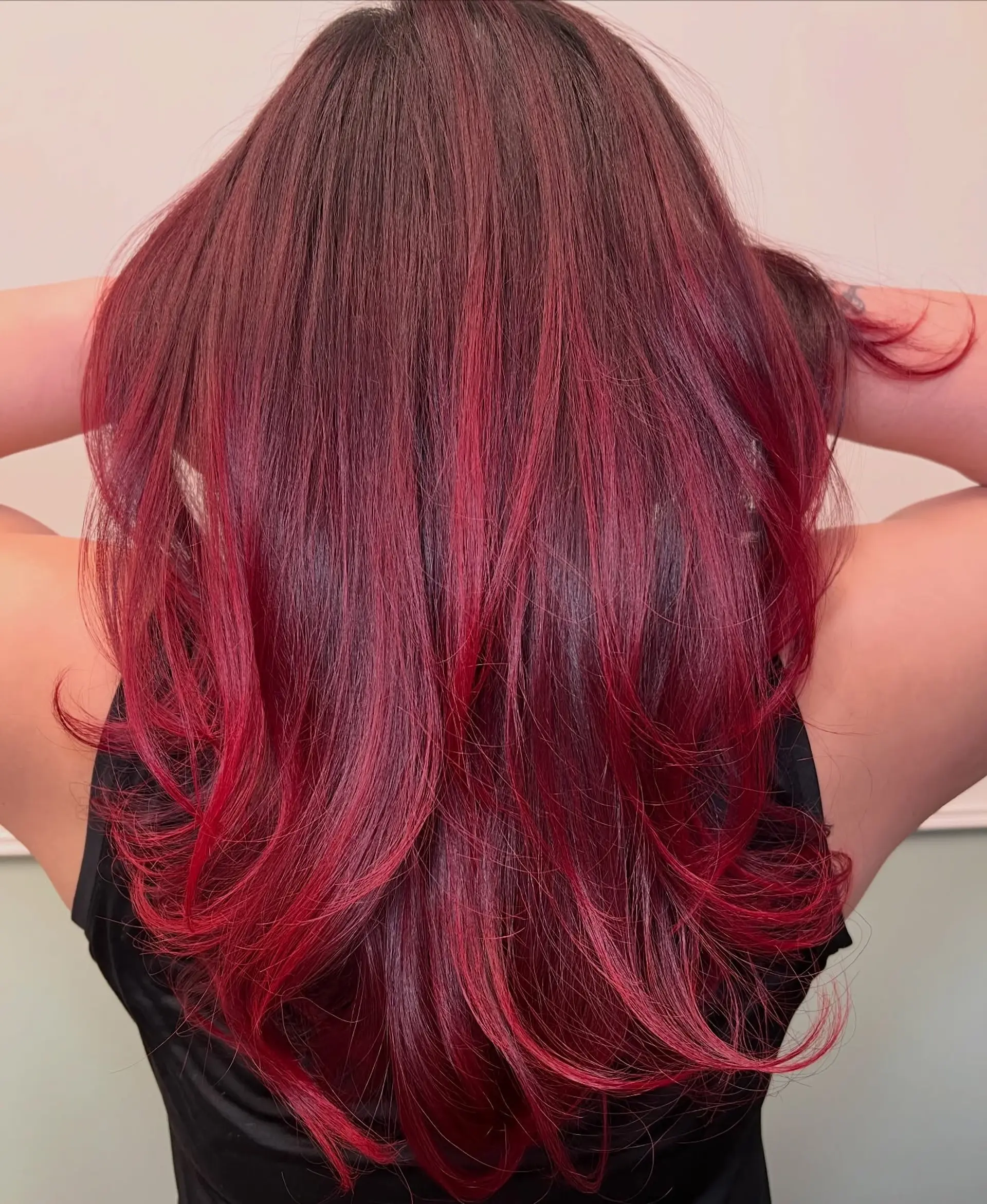 Vibrant cherry red hair cut into long layers with flipped, rounded ends. 1