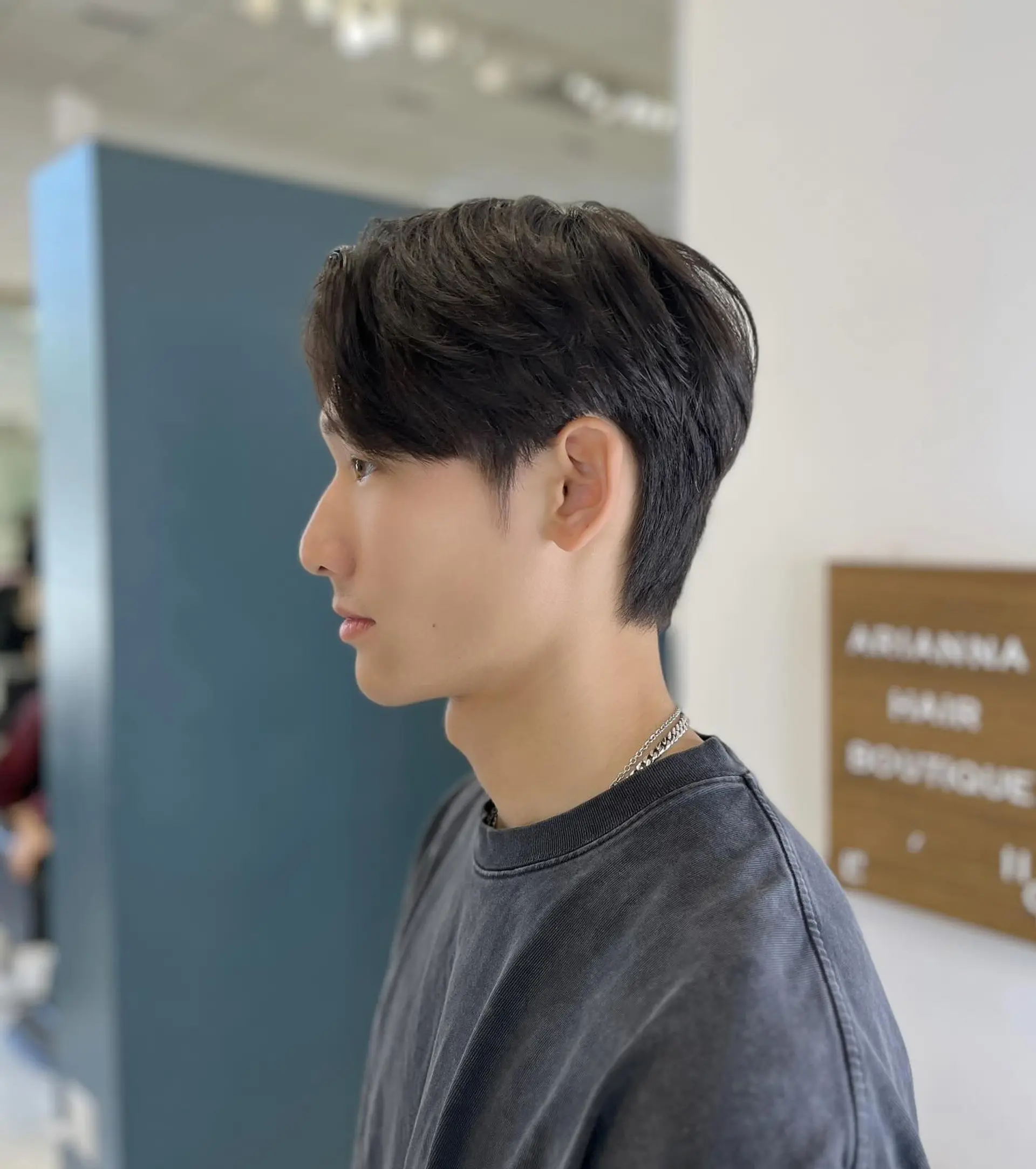 A sleek men's leaf cut styled with soft sweeping layers framing the face and a clean, tapered nape. 1