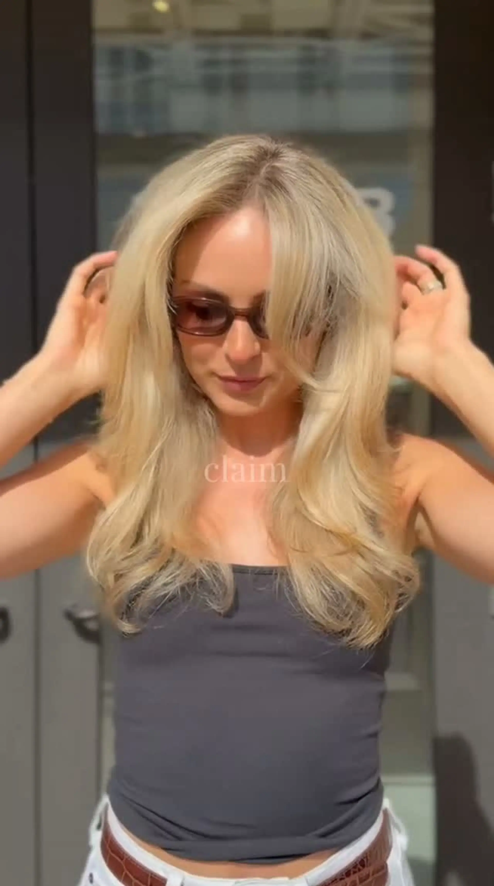 Voluminous, bouncy blonde blowout featuring layered face-framing curtain bangs and softly curved ends. Estimate scope: Styling only: from $65 for the published Rising Star blowout-with-hot-tool tier. This is not a verified quote for any specific stylist; no stylist-to-tier mapping is established. Blonde color, cutting and any other unselected work are not priced by this mapping. 1