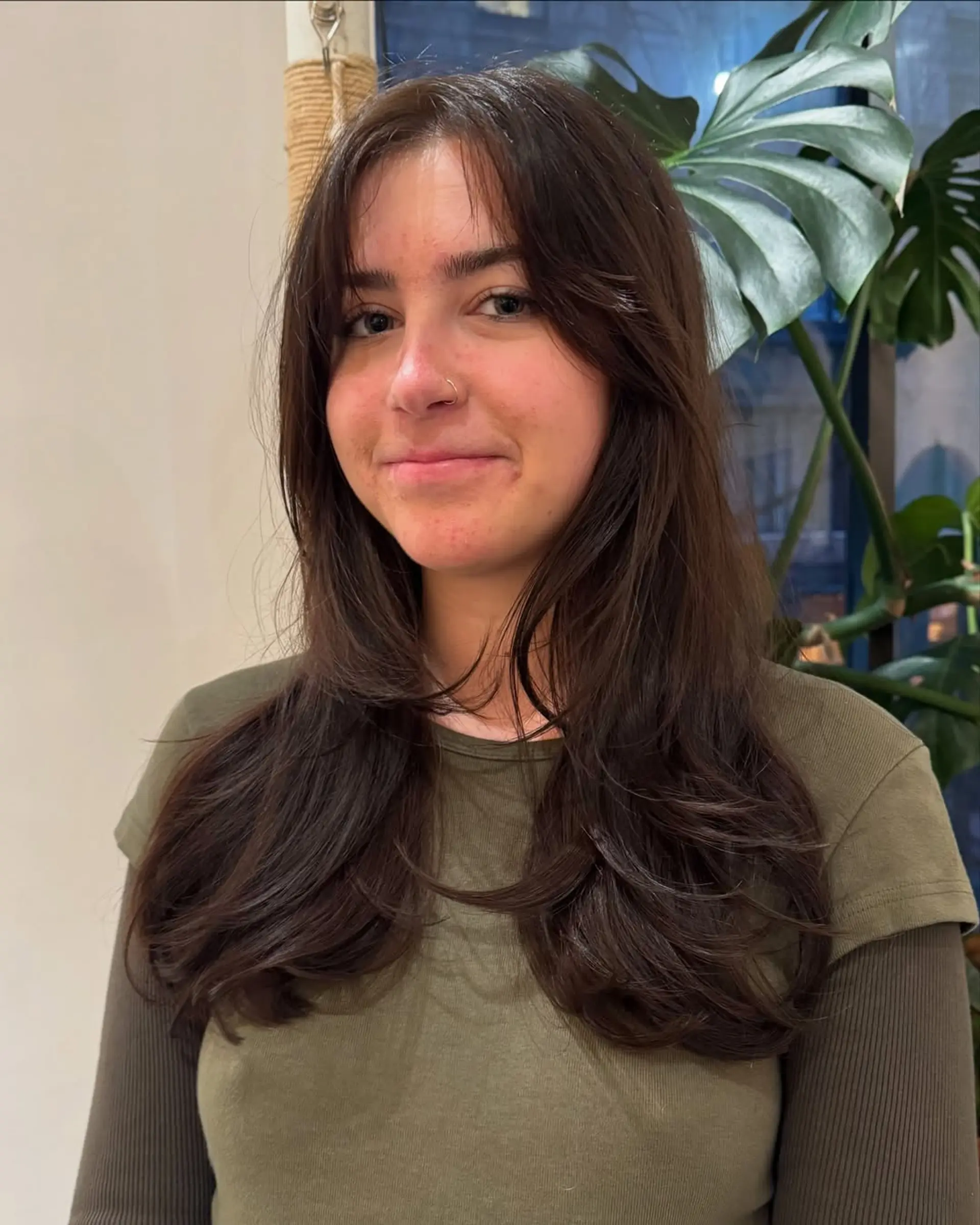 Long layered haircut with face-framing layers and curtain bangs. 1