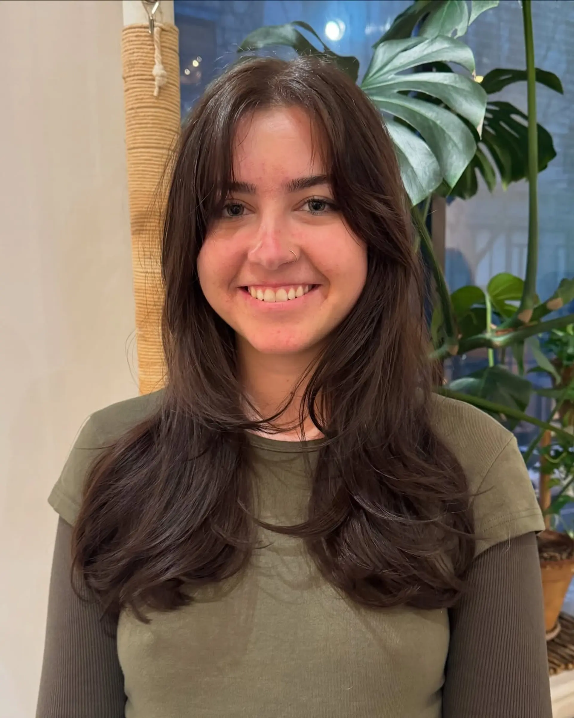 Long layered haircut with face-framing layers and curtain bangs. 2