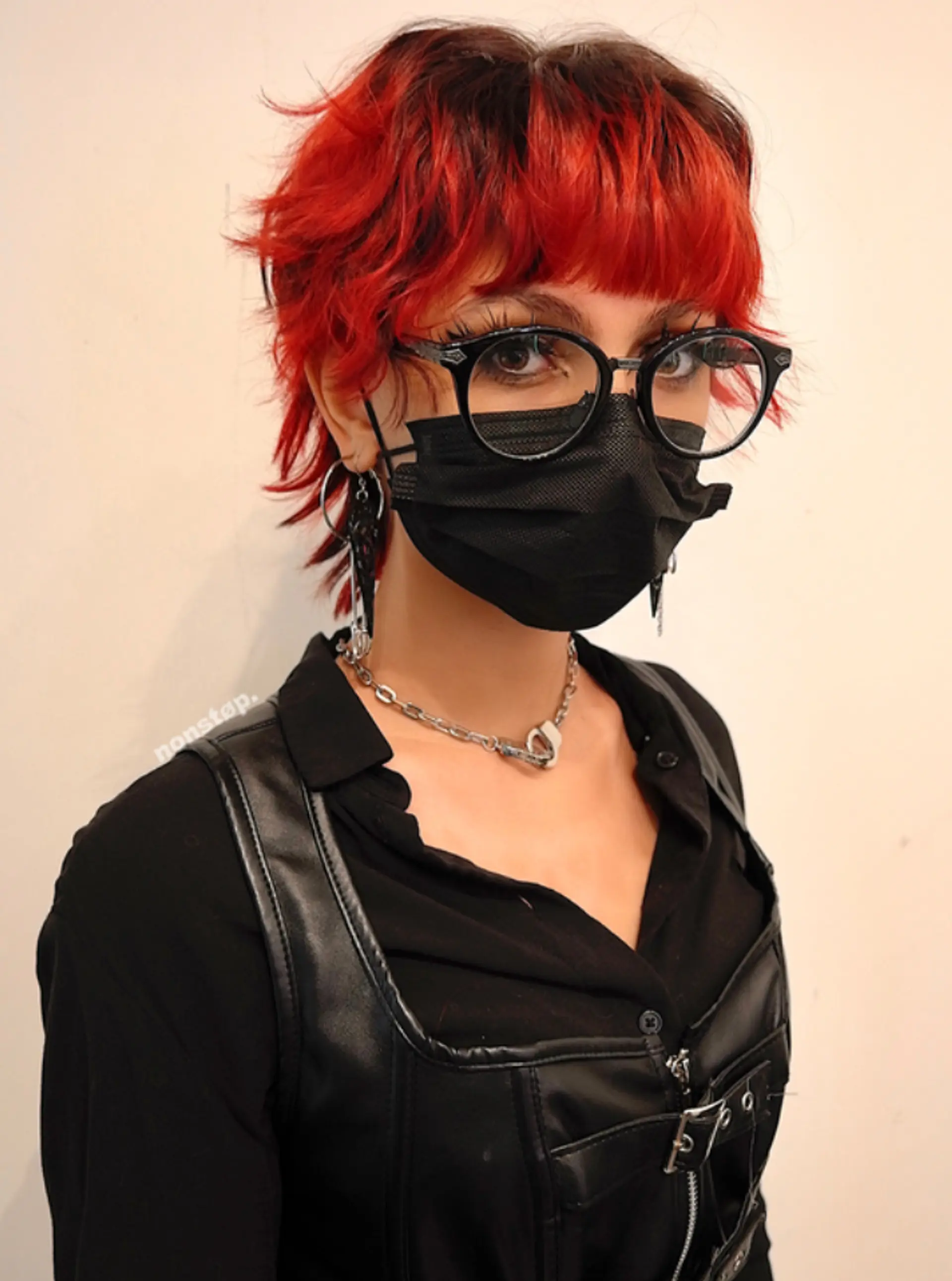 A striking, wavy, short haircut with vibrant red and black colors. It features layers and a choppy, shaggy texture with a bold fringe, giving an edgy vibe.
(NonstopStyle: by Kris) 1