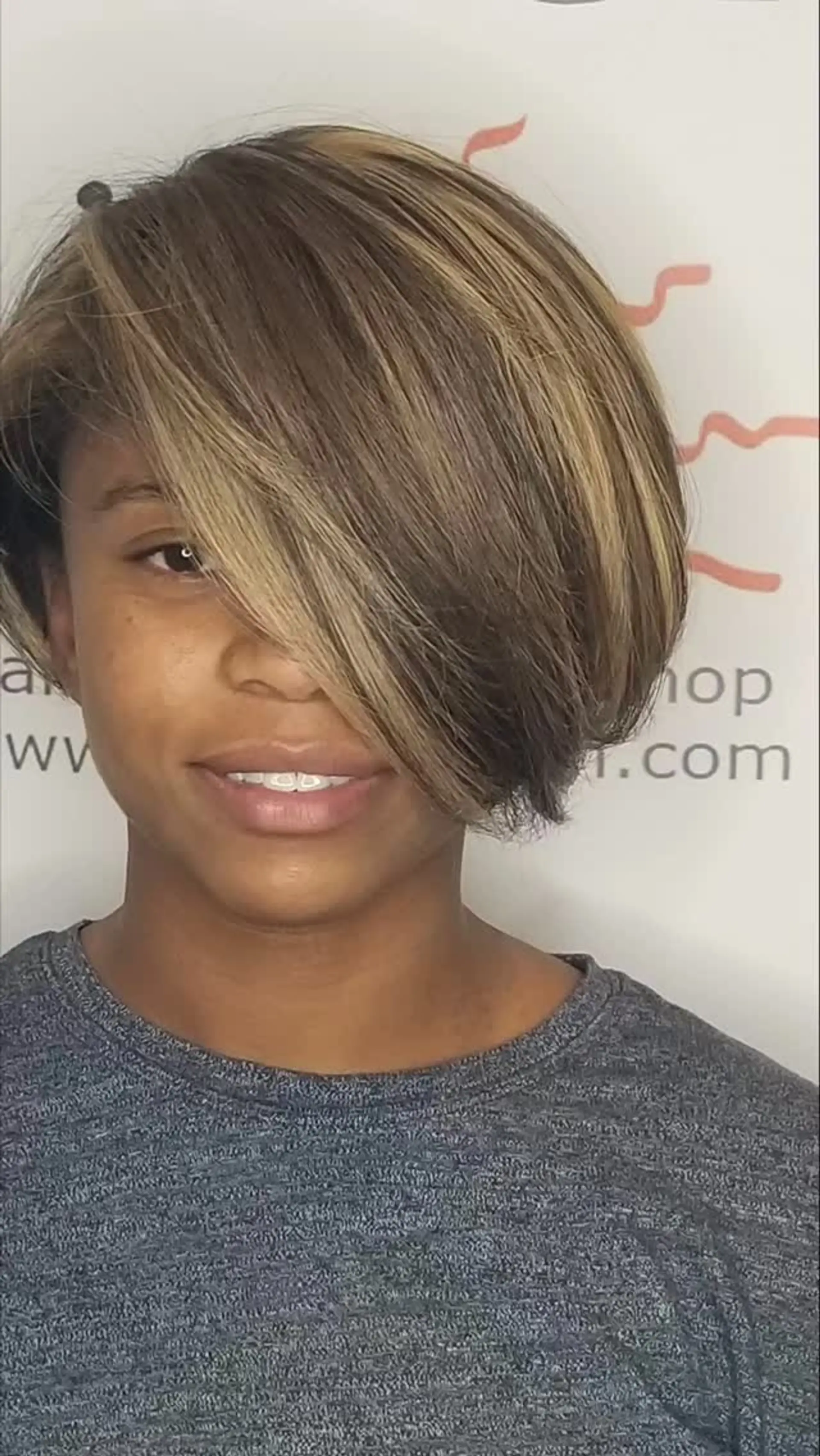 A stylish short asymmetrical bob cut with dramatic side-swept bangs and multi-toned blonde highlights. 1
