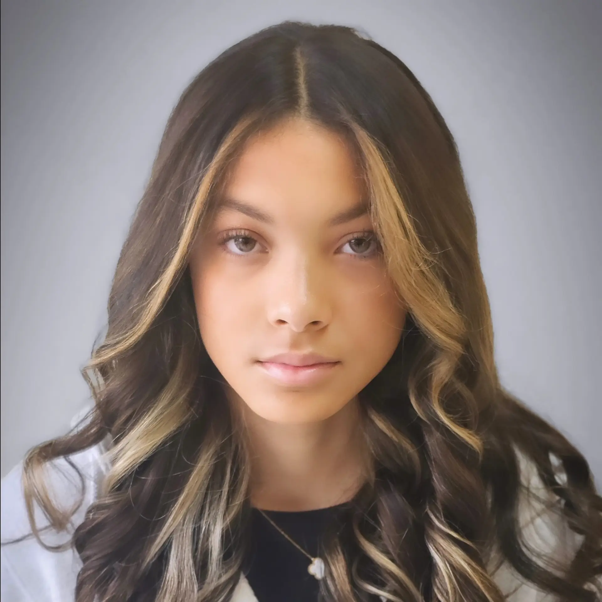 Long dark brown hair styled with soft, voluminous curls featuring high-contrast honey blonde face-framing money piece highlights. 1