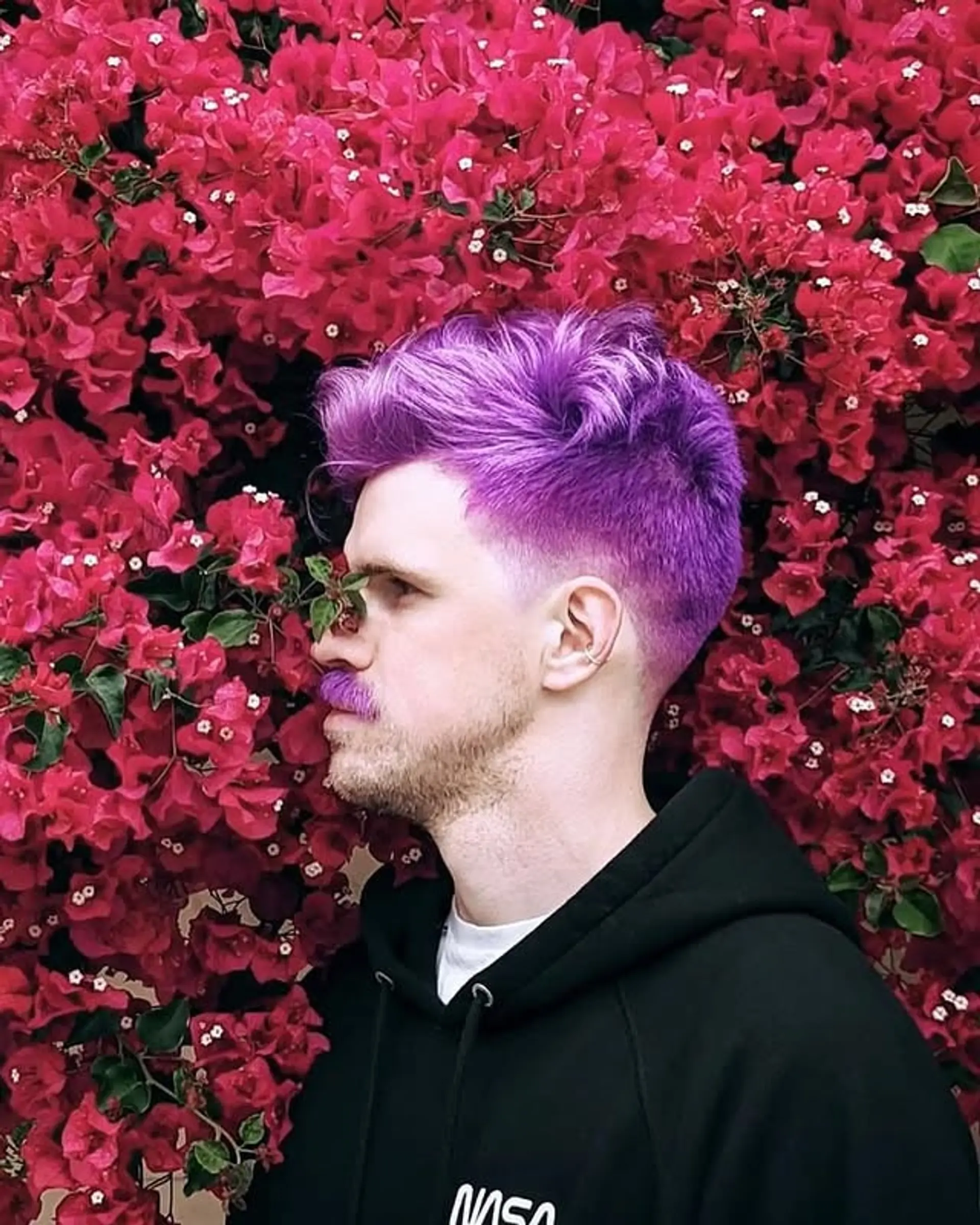 Short, taper fade hairstyle with a bold, vivid purple color. 1