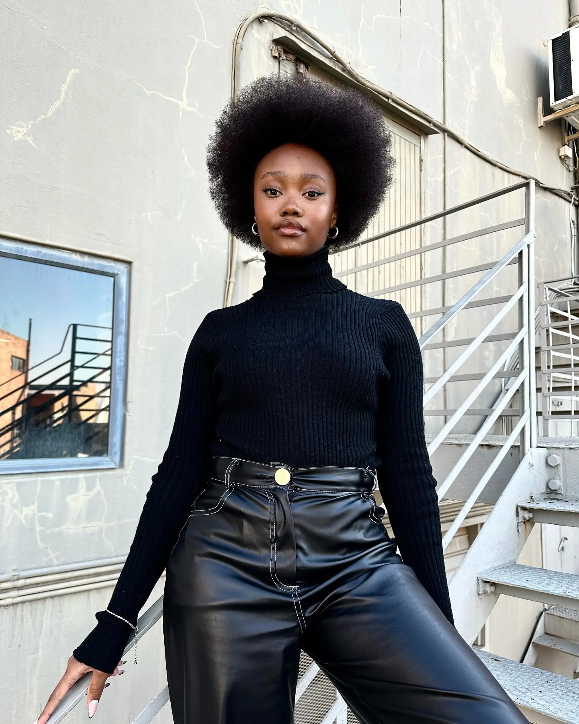 A perfectly rounded, voluminous afro accentuating natural coily texture. 1