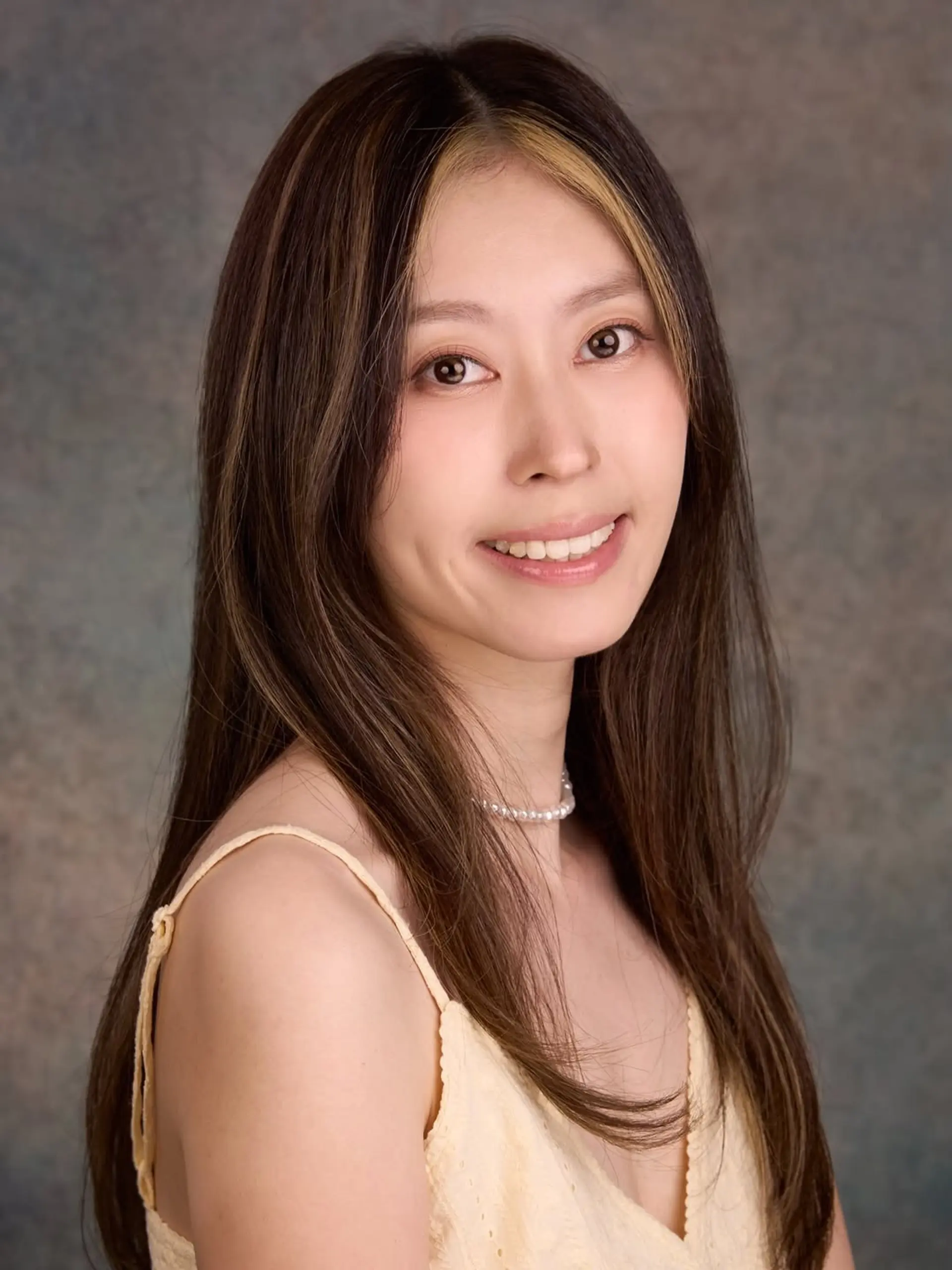 Sleek, long dark brown hair styled with a center part and bright blonde face-framing money piece highlights. 1