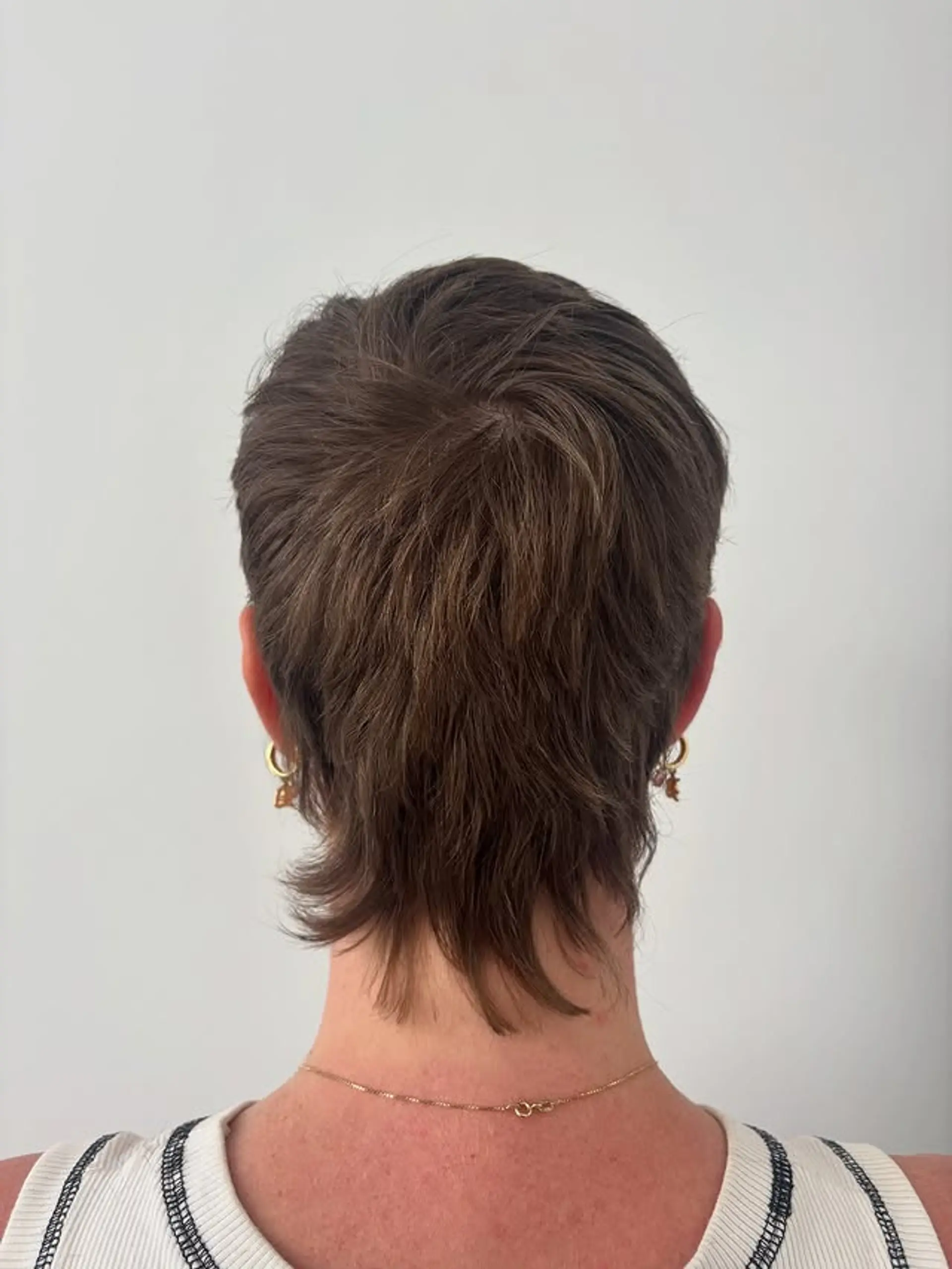 A short, shaggy mullet with textured layers. 1