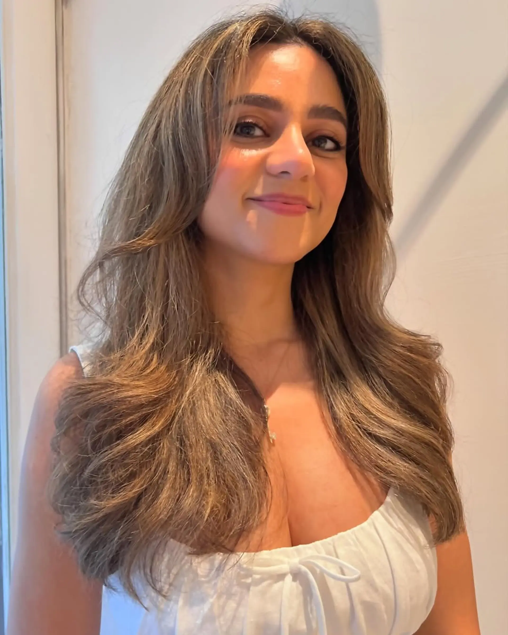 Voluminous layered long hair with curtain bangs. 1