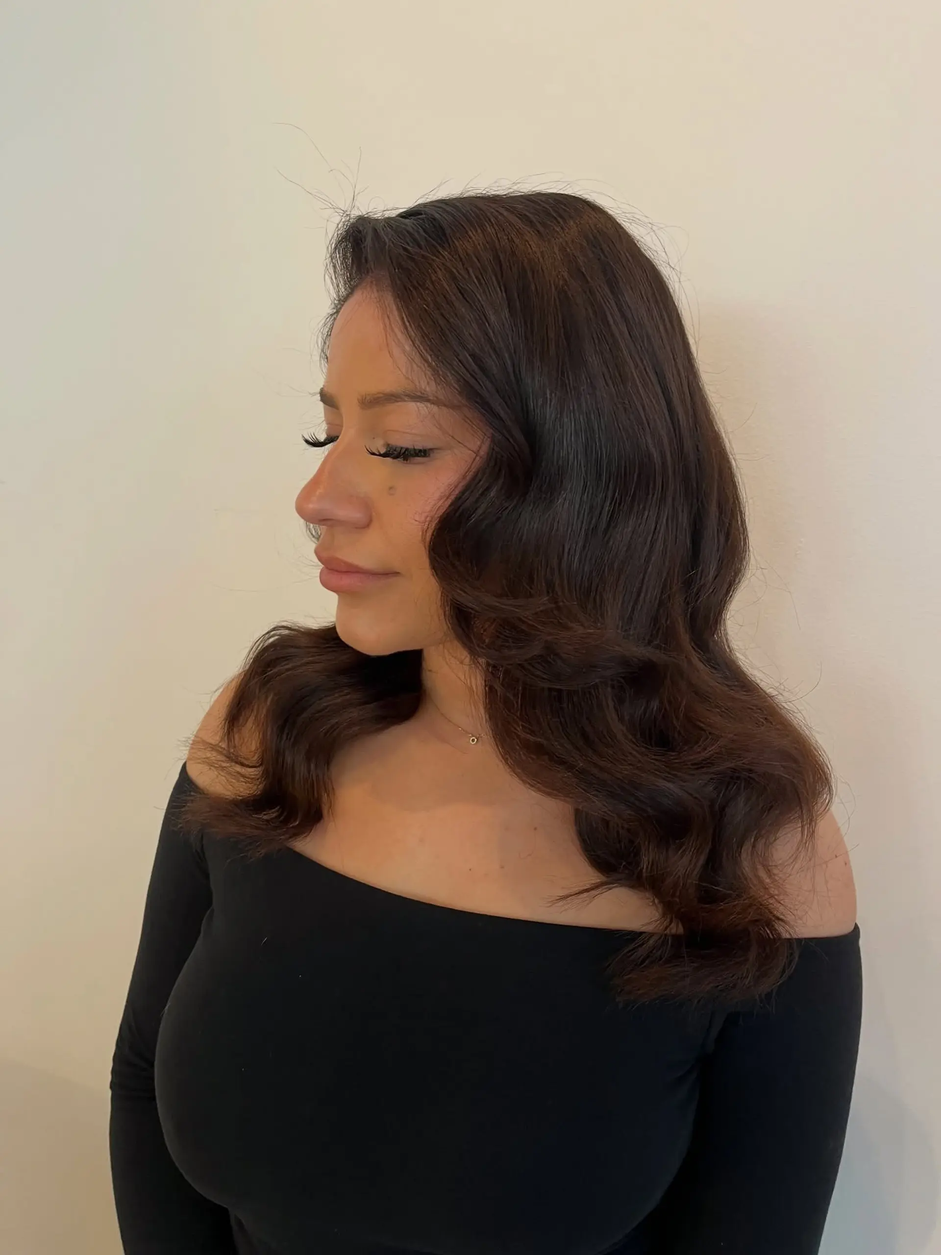 Glossy espresso-toned hair styled in classic, voluminous Hollywood waves draped over the shoulders. 1