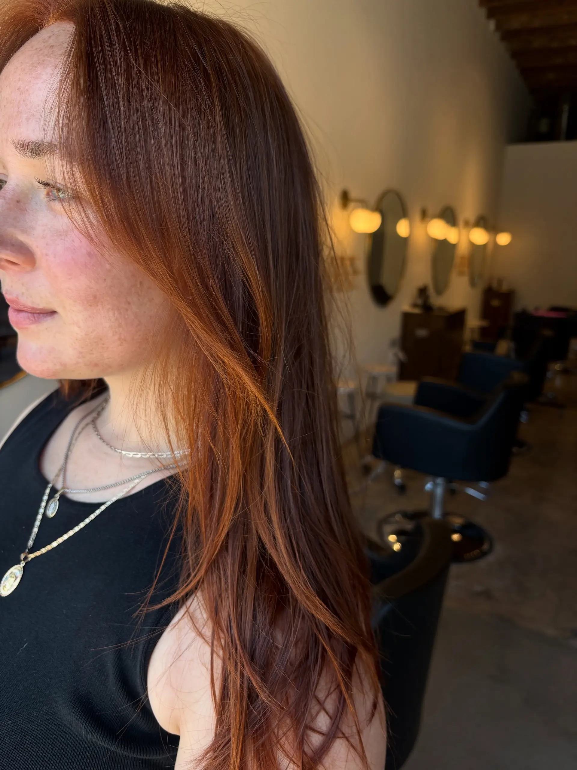 Long, smooth auburn hair with subtle copper tones and light face-framing layers. 1