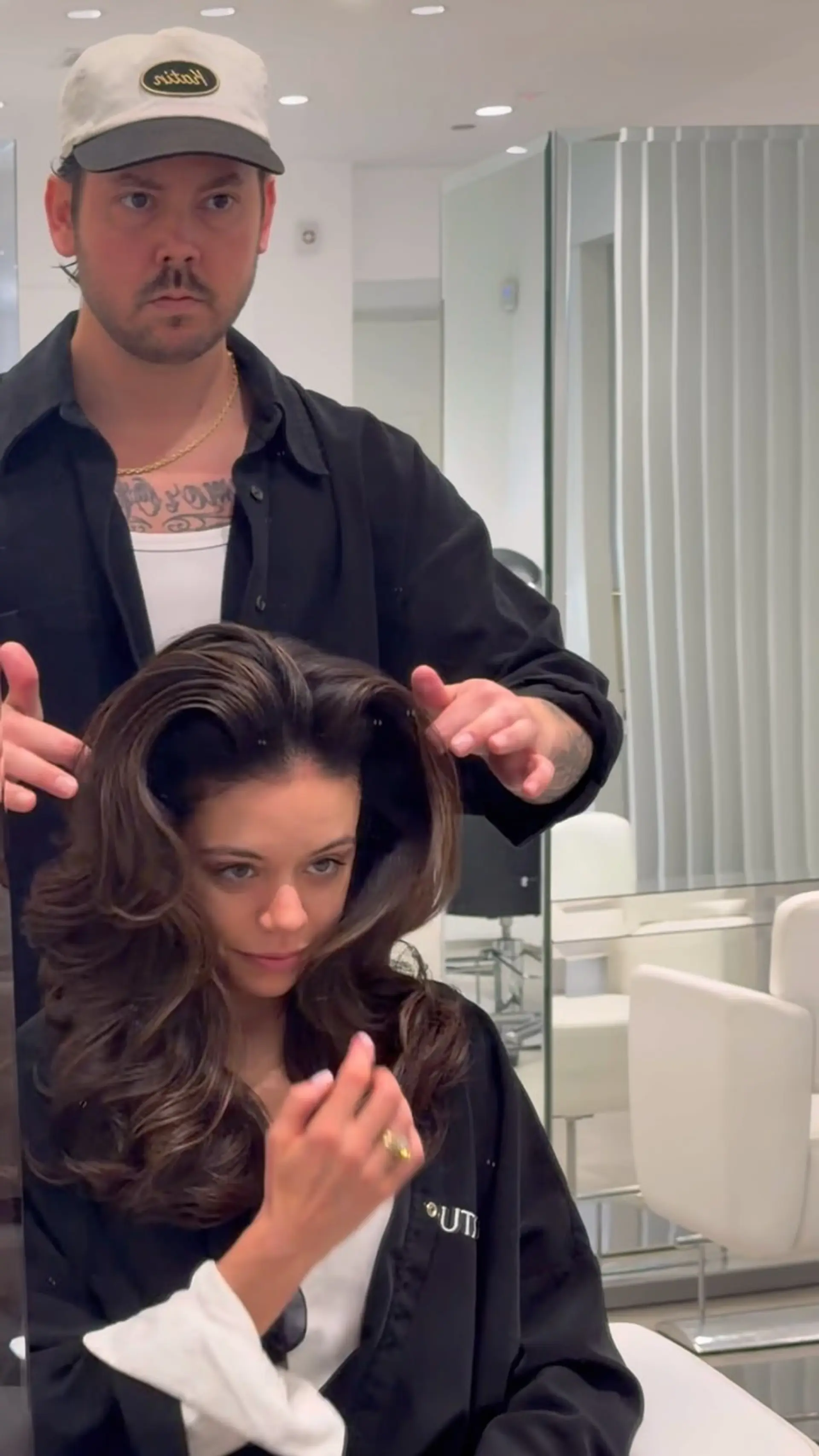 A glamorous, voluminous brunette blowout styled with big bouncy waves and sweeping face-framing layers. 1