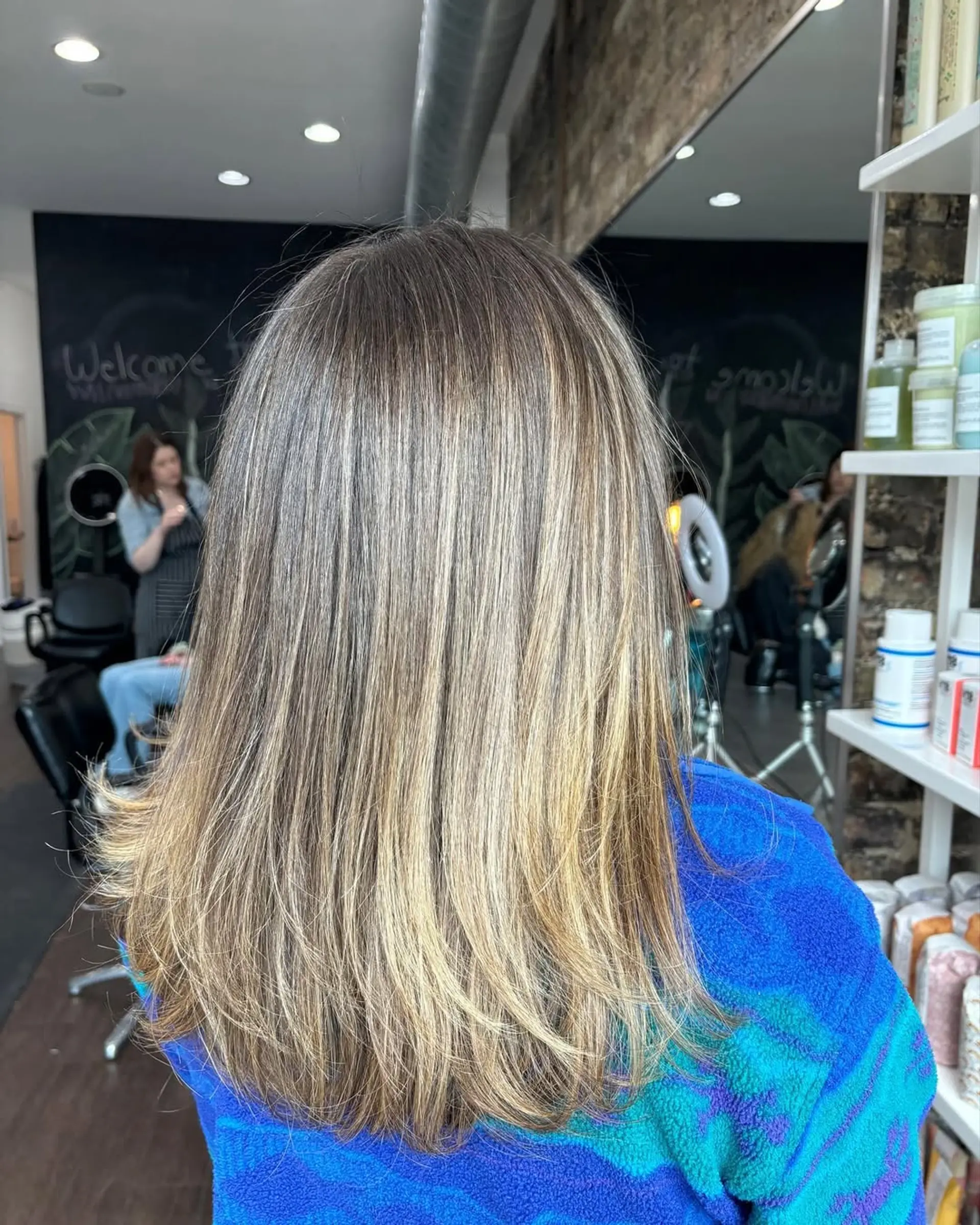 Medium-length straight hair with natural roots transitioning into dimensional ash and golden blonde balayage highlights, finished with soft layers. 1