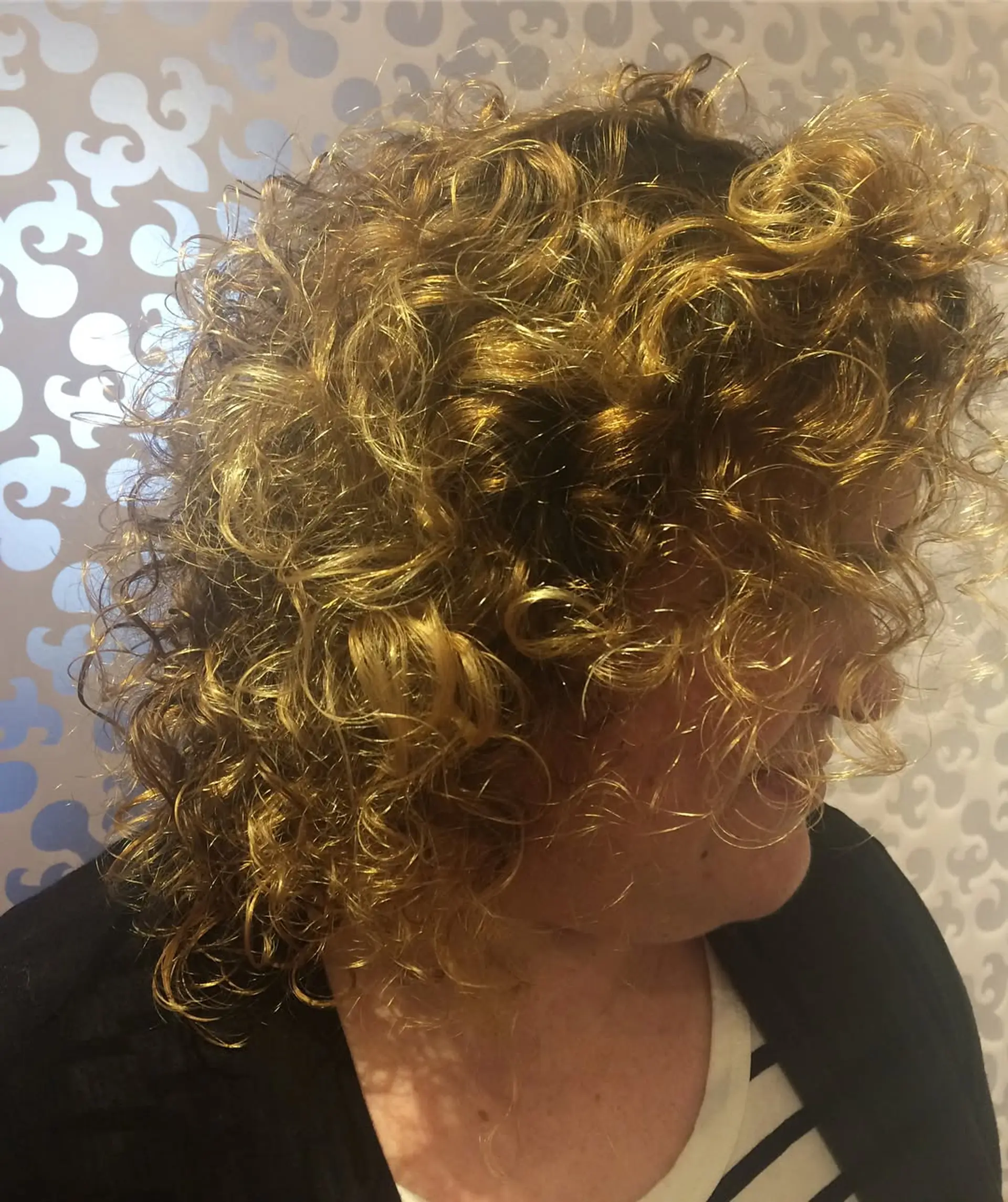 A curly bob with a blend of blonde and brown highlights for a dimensional look. 1