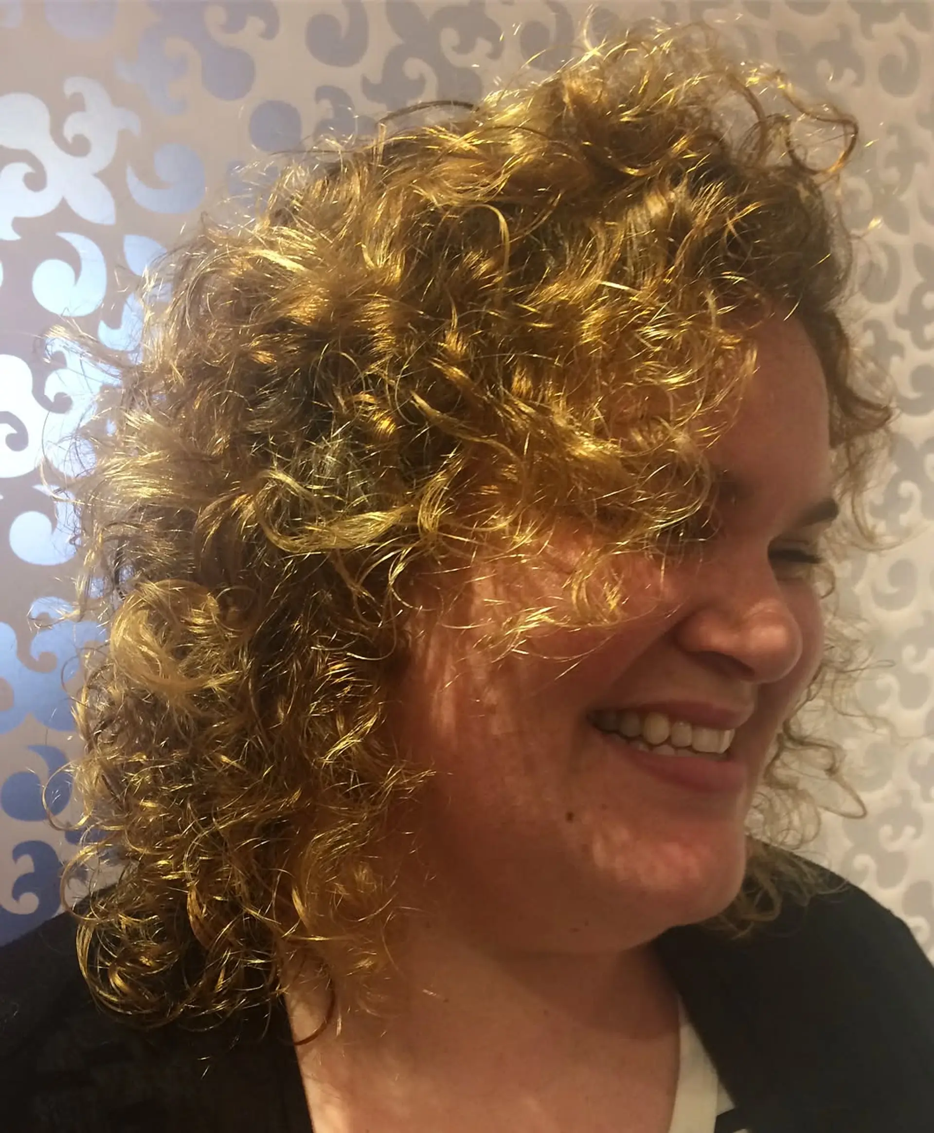 A curly bob with a blend of blonde and brown highlights for a dimensional look. 2