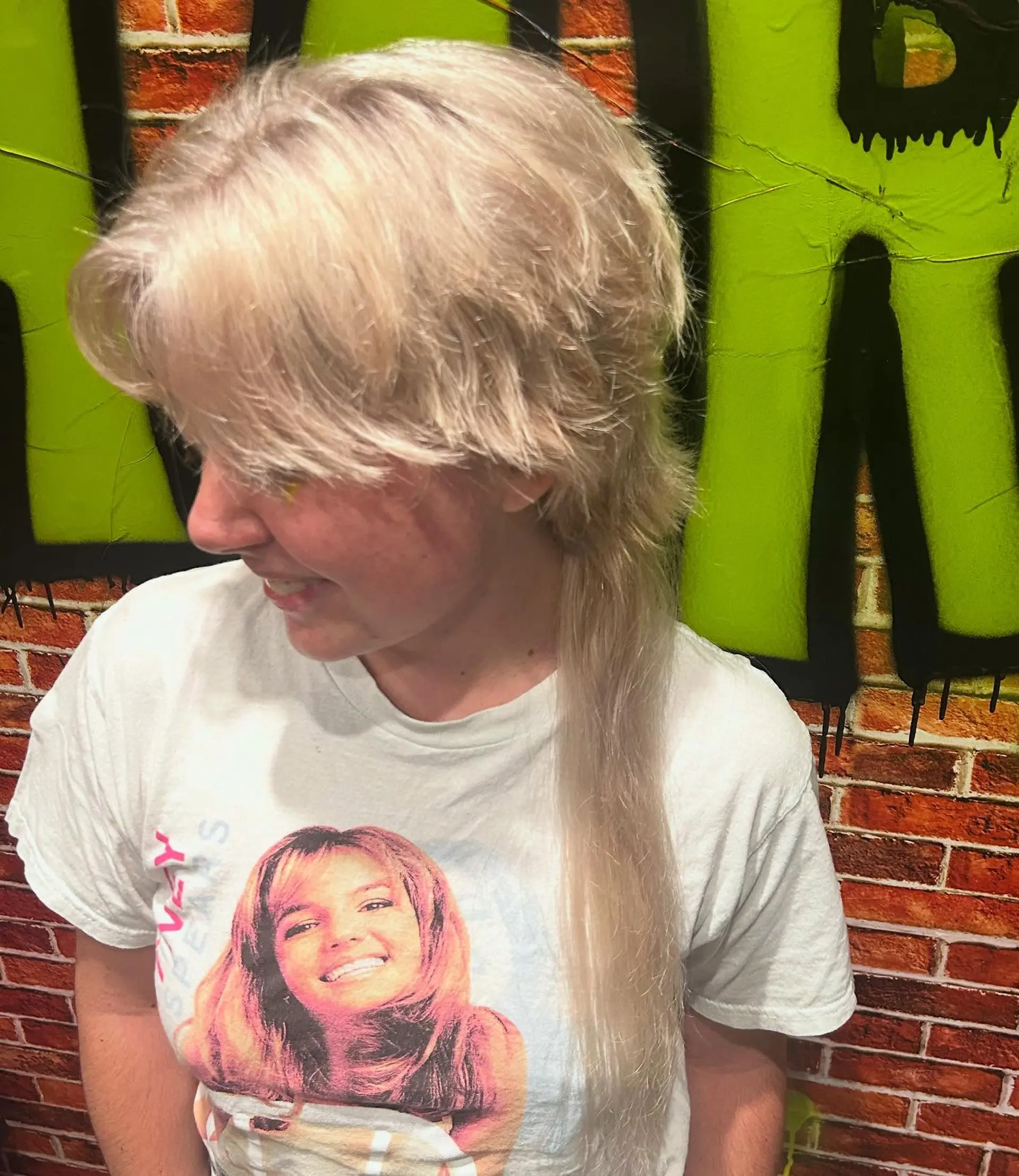 A heavily layered platinum blonde shag featuring feathered face-framing fringe and a single elongated rat tail. 1