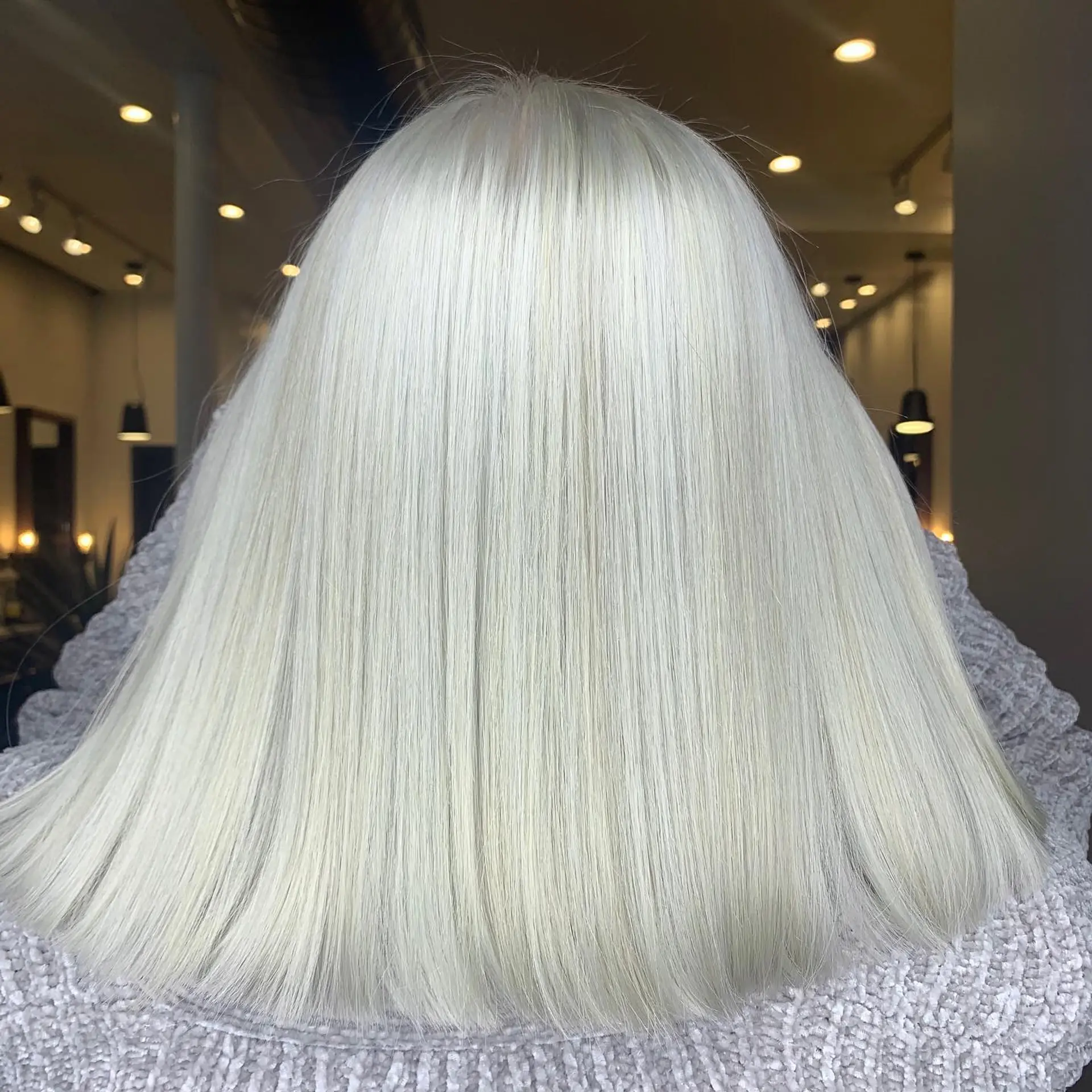 Long, straight hair with a clean, uniform cut and an icy platinum blonde color. 1