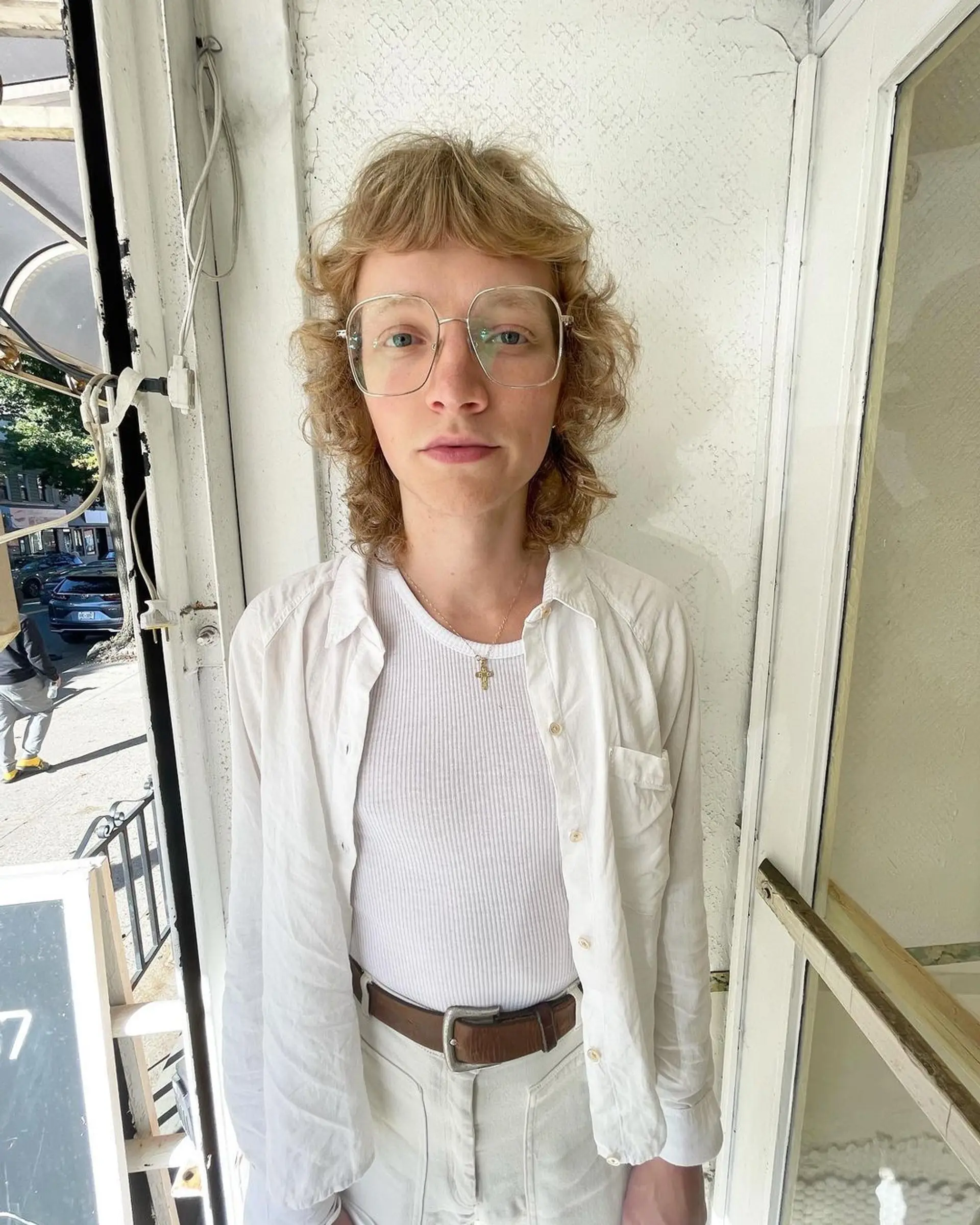 Medium-length, honey gold curls with a soft fringe and layered for volume, creating a retro and casual elegant look. 3