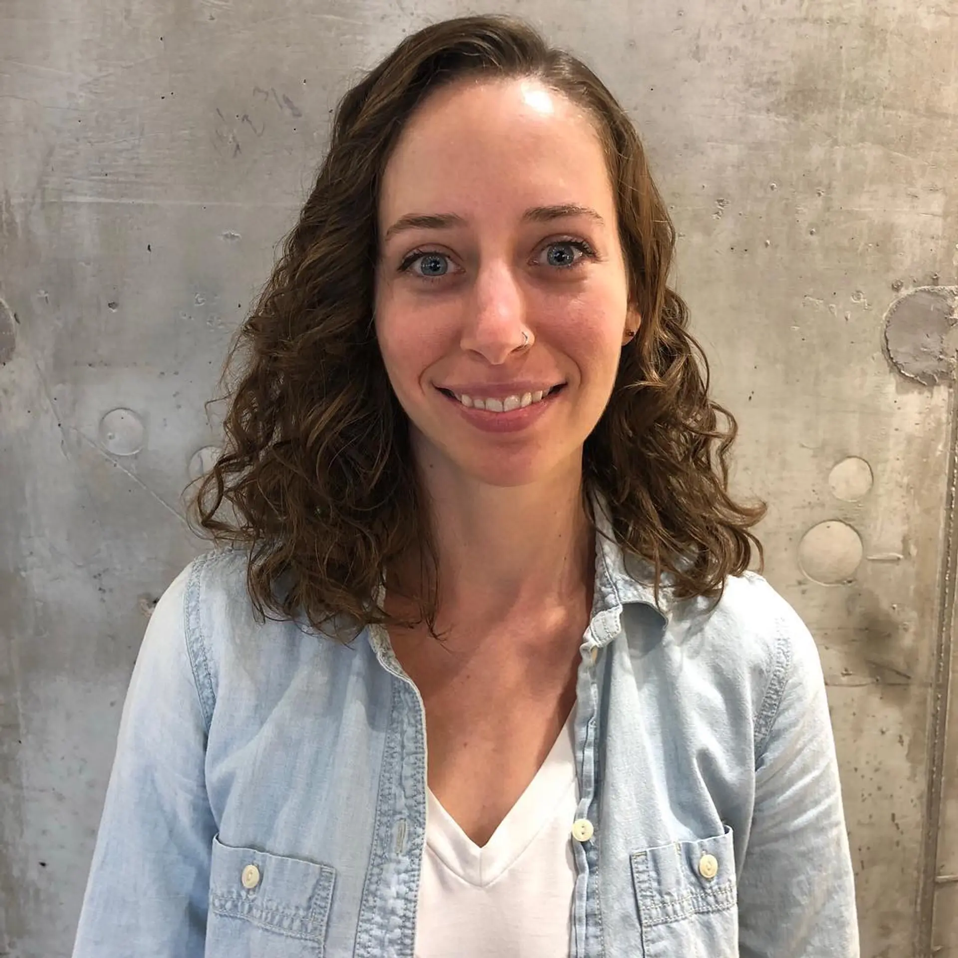 Shoulder-length naturally curly hair styled with defined, soft curls and a side part. 1