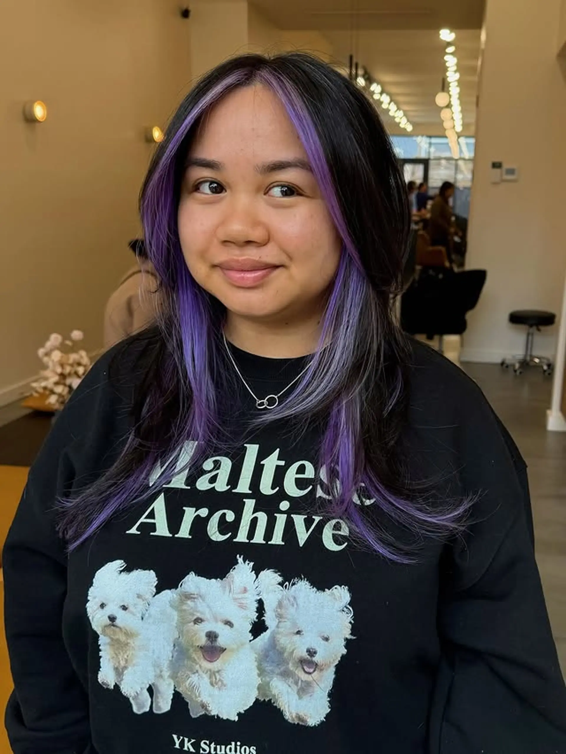 A black base with face-framing purple highlights. 1