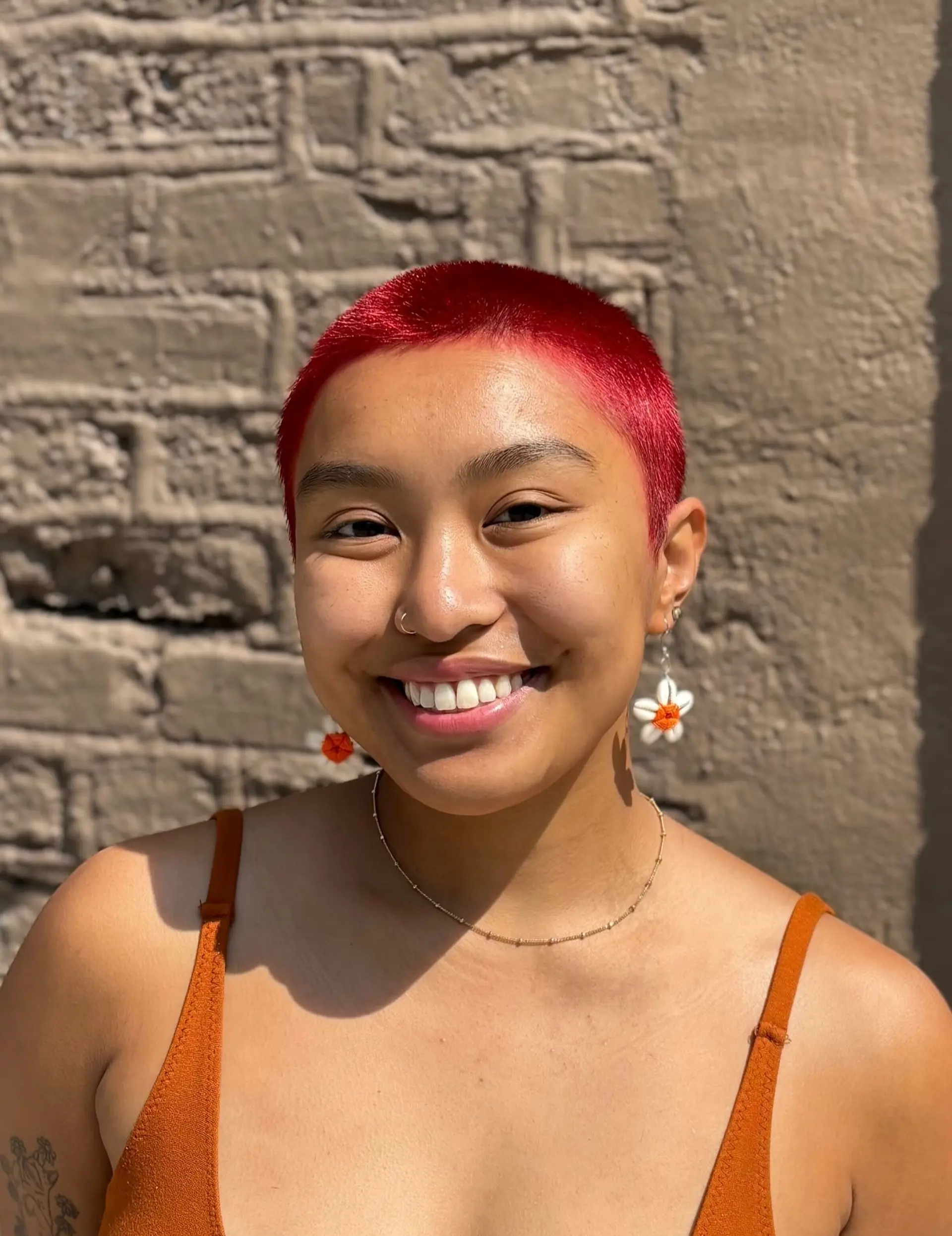 A stylish buzz cut with a vibrant, red color. 2